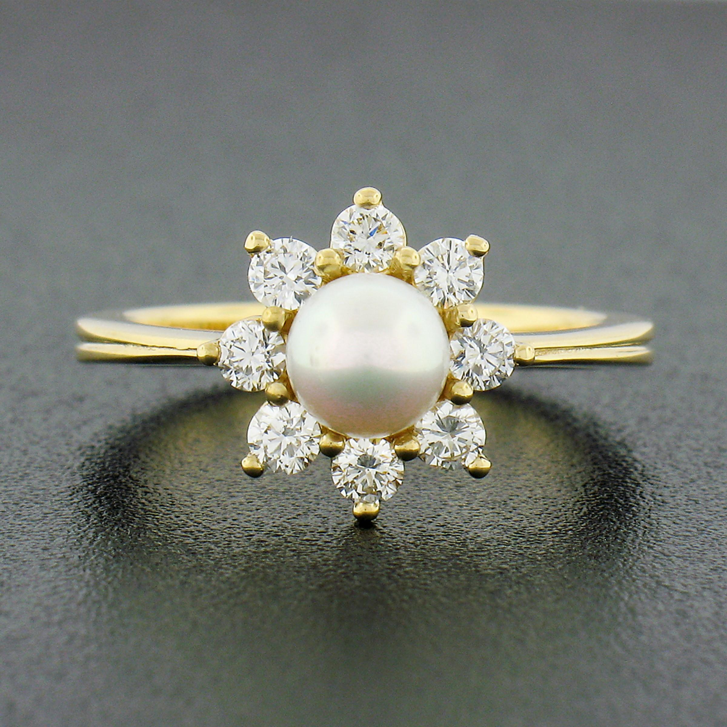 This classic pearl and diamond flower cluster ring is newly crafted in solid 18k yellow gold. It is neatly set at the center with a round cultured pearl that shows a nice white color with amazing luster. The pearl is further surround and accented by