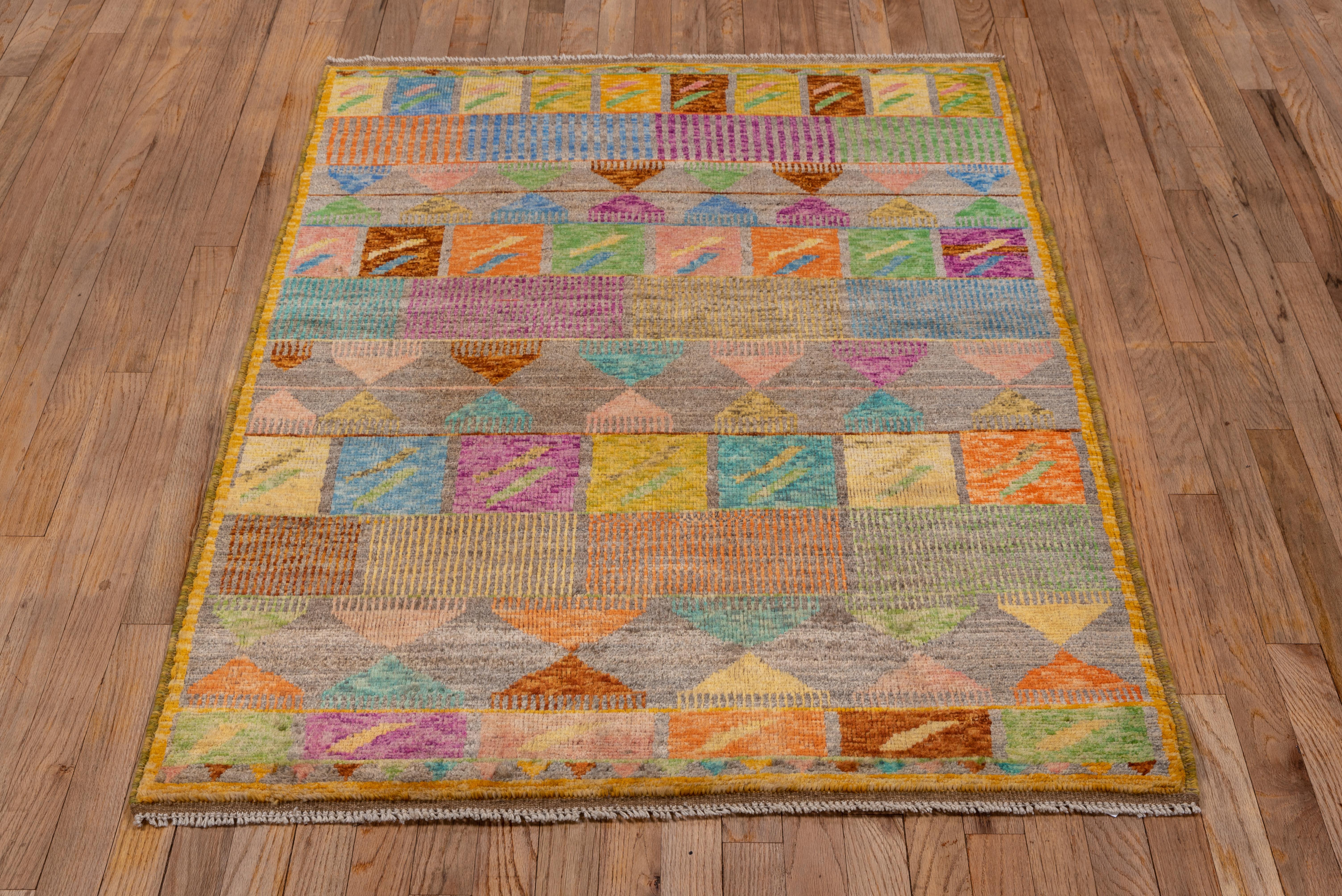 Triangular combs, rectangles with arrays of parallel lines and squares with check marks, form row across this small scatter with a straw to marigold border. The palette tends to the soft side, with abrashed tones of aqua, rust, light and pale blue,