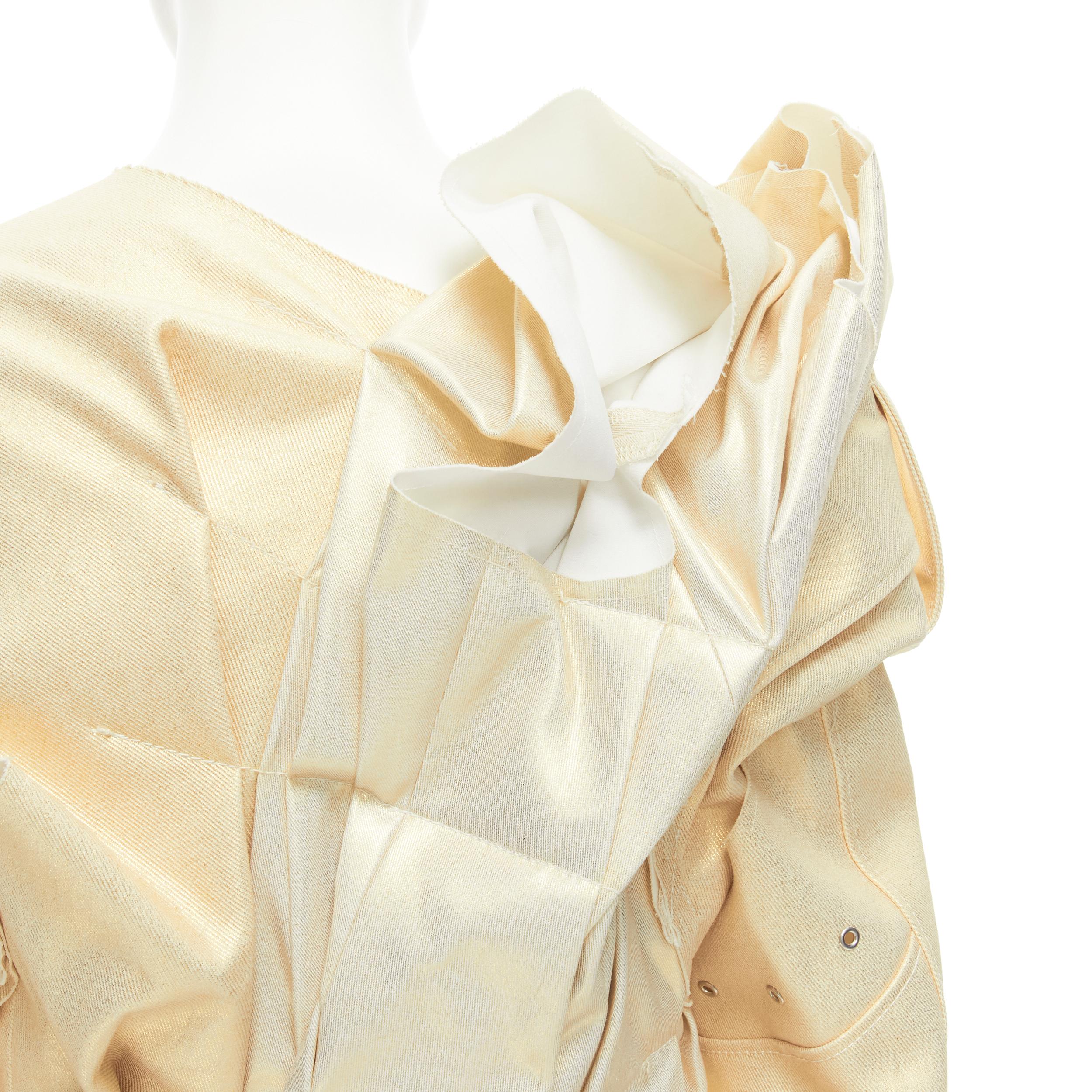 new COMME DES GARCONS 2012 gold coated cotton ruffle deconstructed bundled coat M 
Reference: CRTI/A00463 
Brand: Comme Des Garcons 
Collection: 2012 
Material: Cotton 
Color: Gold 
Pattern: Solid 
Extra Detail: Open front. Zipped cuff. 
Made in: