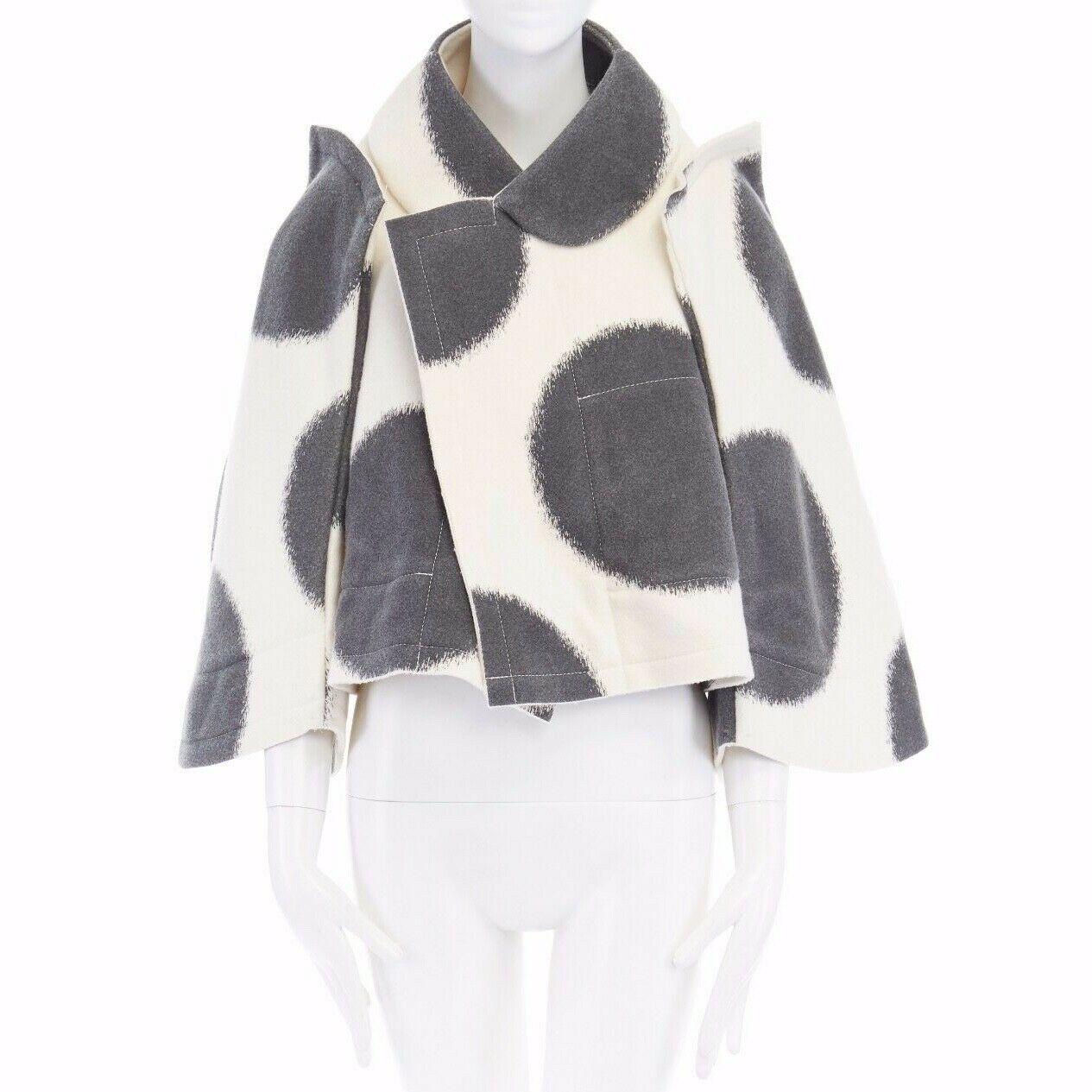 COMME DES GARCONS 
FROM THE FALL WINTER 2012 COLLECTION
Nylon, cotton, wool • Cream base with black large polka dots • Flat packed design • Stiff structured wool-felt • Rounded collar • Curved structured sleeves • Protruding shoulders • White