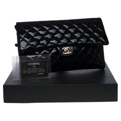New Condition- Chanel Clutch in black patent quilted leather, Champagne hardware