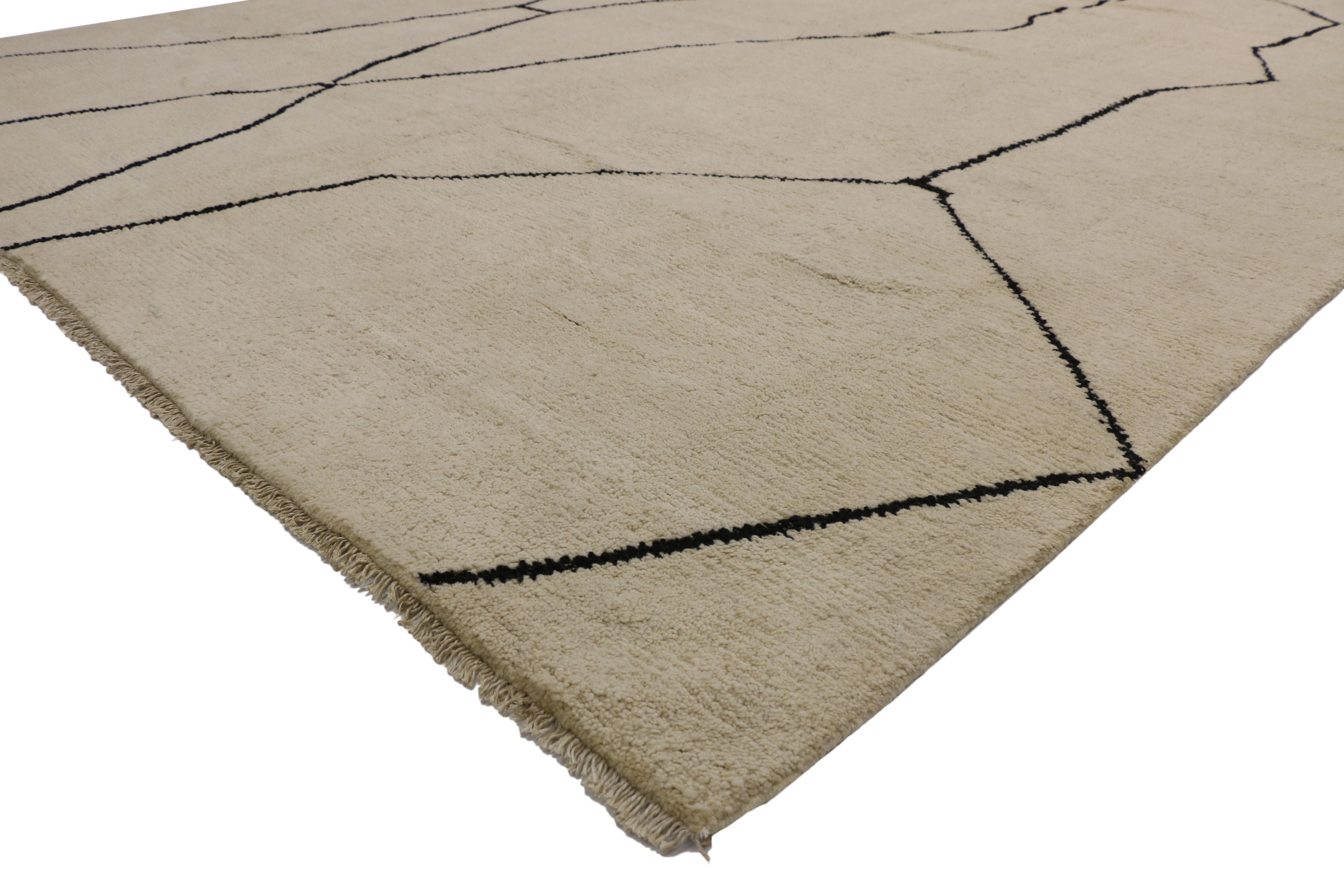 80514, new contemporary Moroccan area rug with metamorphic design and modern style. This hand knotted wool contemporary Moroccan area rug features contrasting black lines running the length of the sandy-beige backdrop. The Metamorphic marble veins