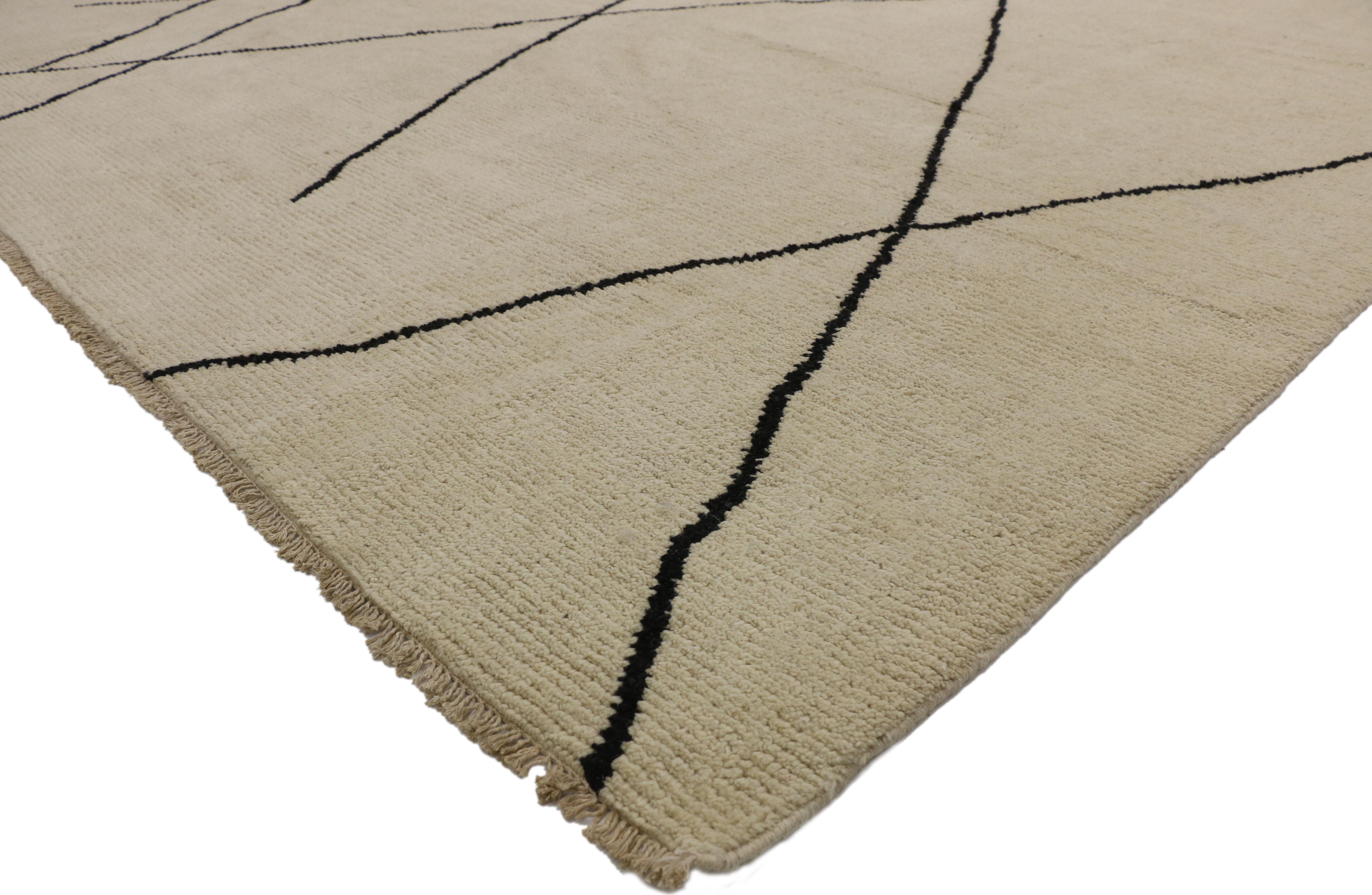 80500, new contemporary Moroccan area rug with modernist style. This hand knotted wool contemporary Moroccan area rug features contrasting black lines running the length of the sandy-beige backdrop. The thin black lines crisscross in an organic