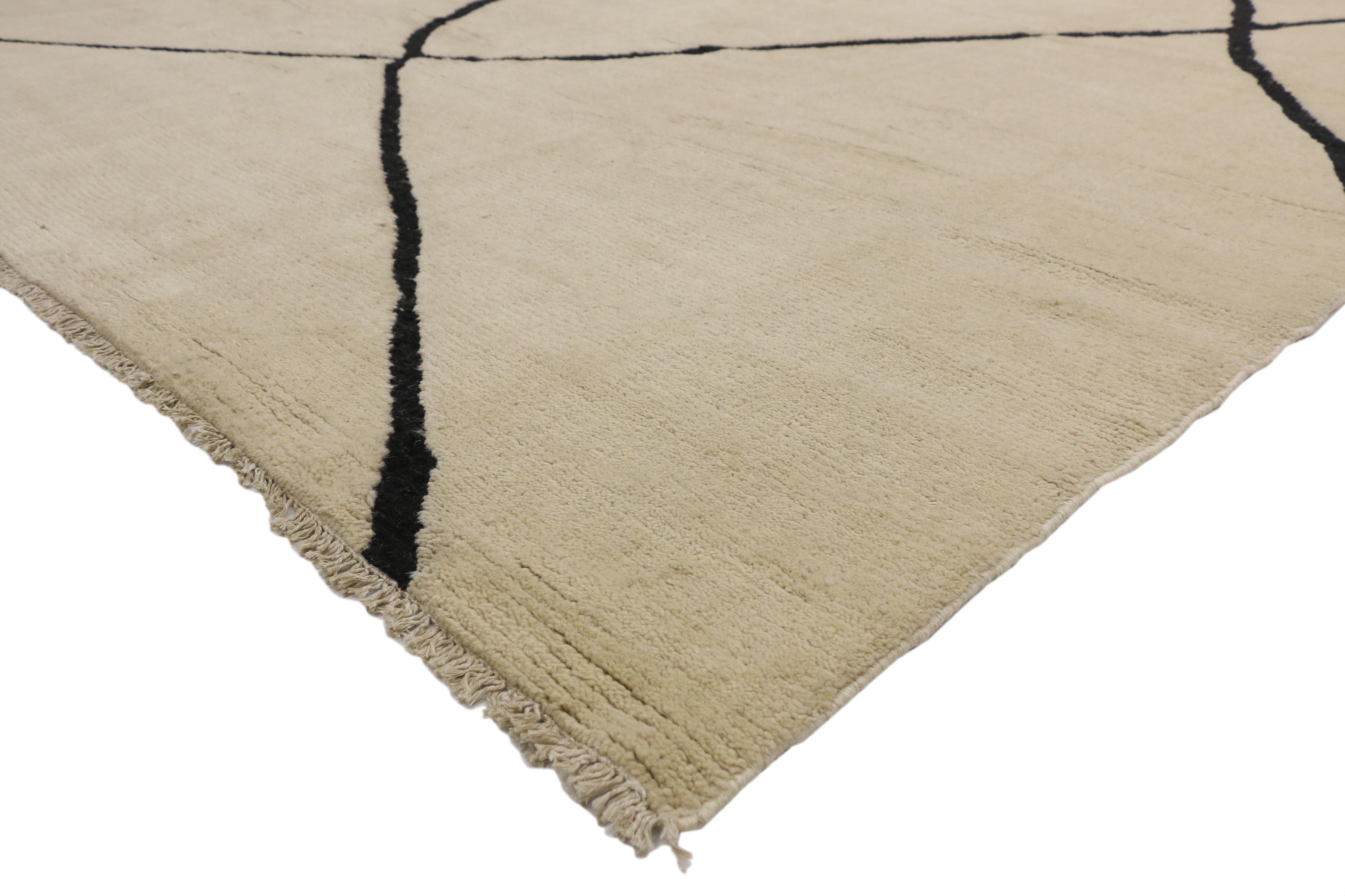 80508 new, Contemporary Moroccan Area rug with Organic Modern style. This hand knotted wool contemporary Moroccan area rug features contrasting black lines running the length of the sandy-beige backdrop. The thin black lines crisscross in an organic