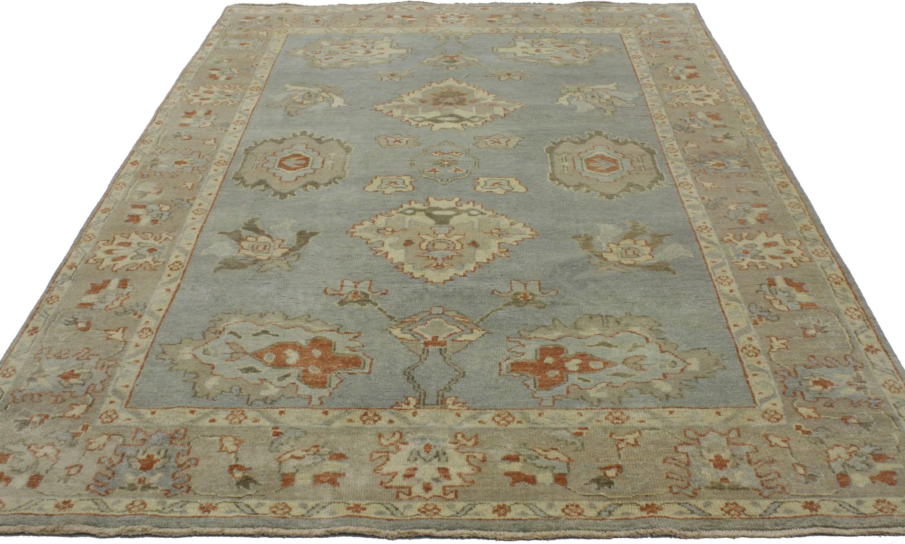 30202, new contemporary Oushak style rug with classic coastal style. This hand-knotted wool contemporary Oushak style rug features large-scale medallions floating in an abrashed blue-gray field. The rug is framed of stylized palmettes and flowers