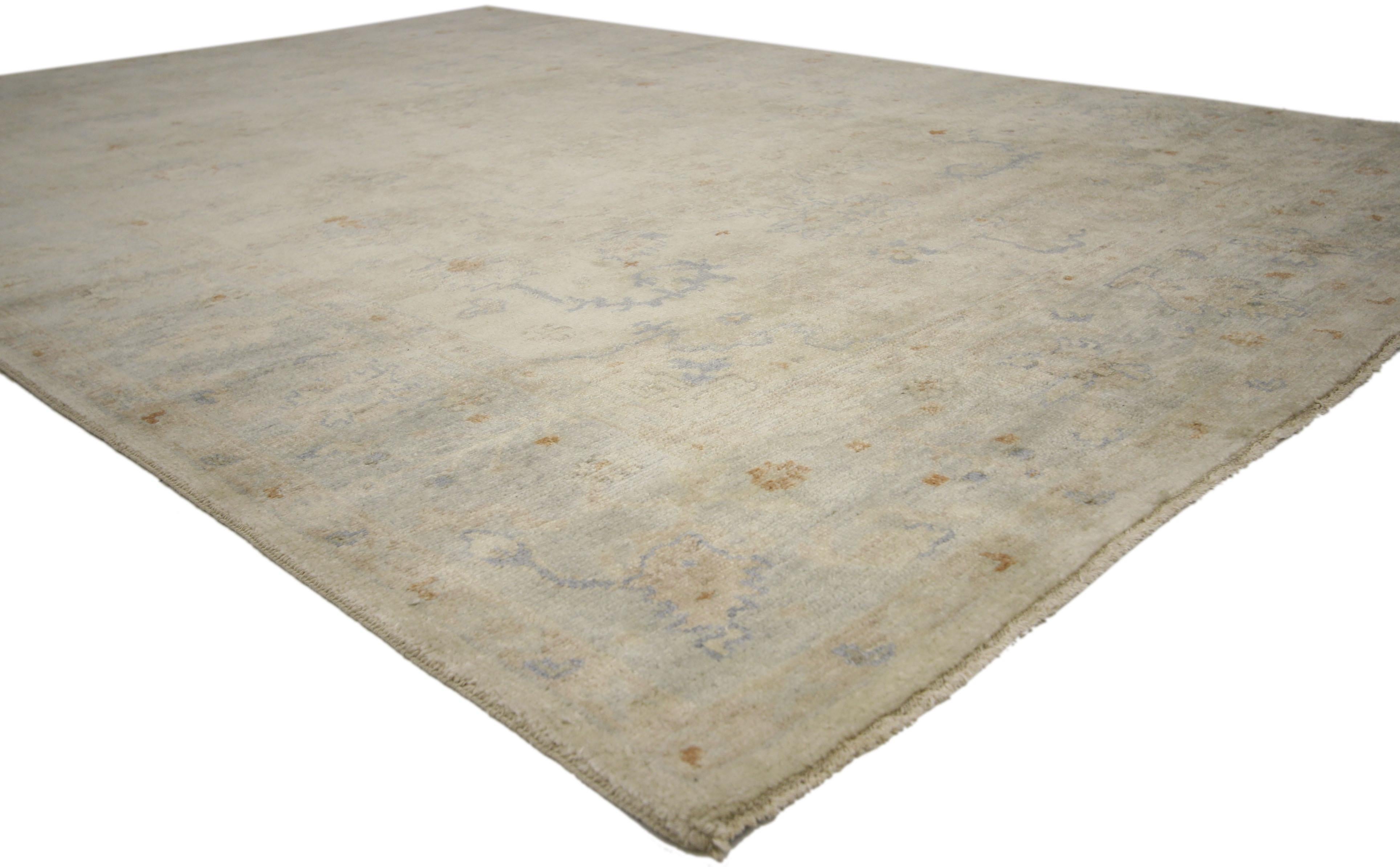 30139, new contemporary transitional Oushak style rug with cool-tone neutral colors. This hand knotted wool contemporary Oushak style rug features an elegant all-over floral pattern spread across an abrashed sandy gray field. A stylized latticework