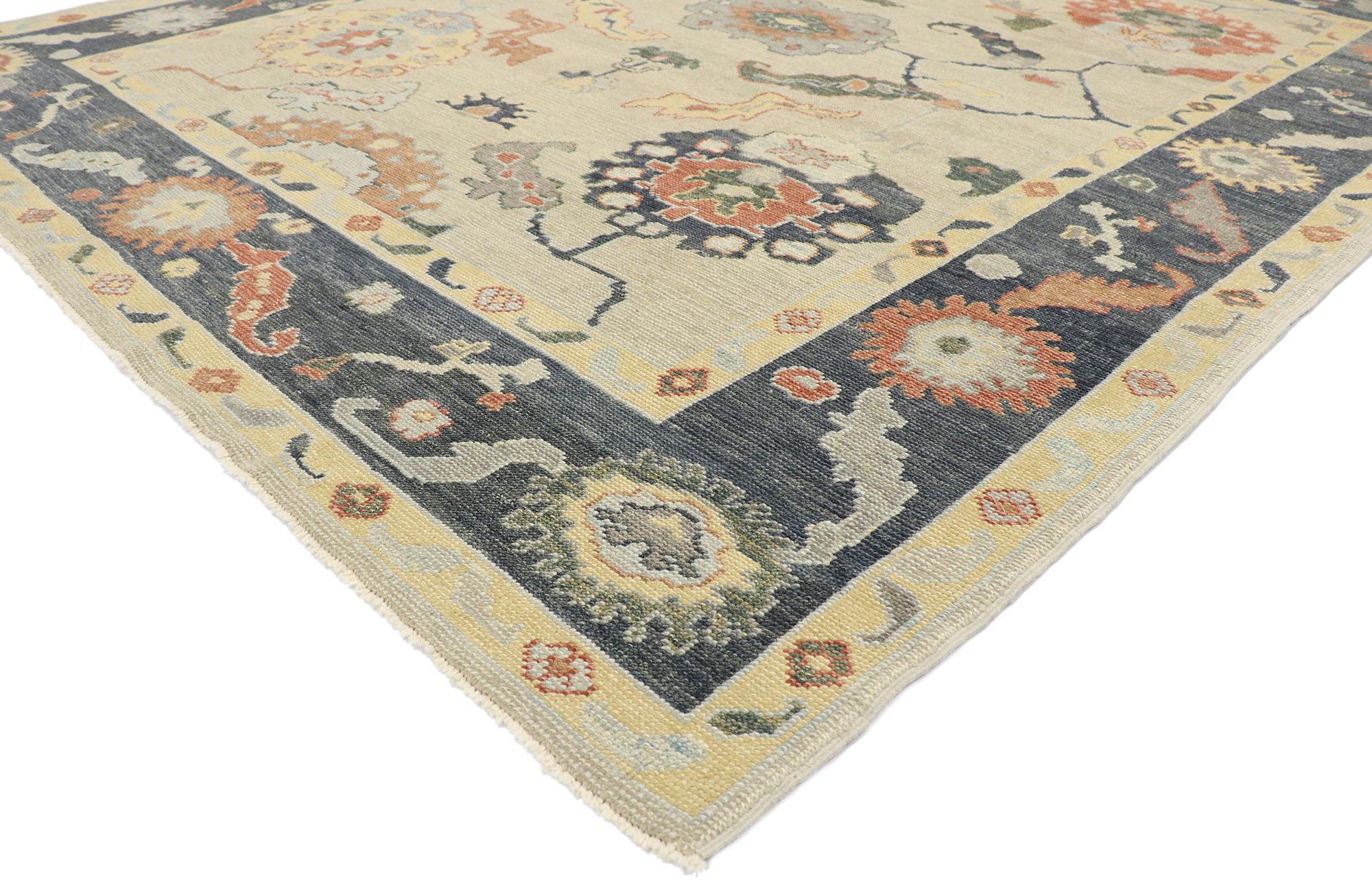 53489, new contemporary Turkish Oushak rug with Modern style. This hand-knotted wool new contemporary Oushak-style rug features an all-over floral pattern spread across an abrashed sandy beige field. An array of botanical motifs decorates the field