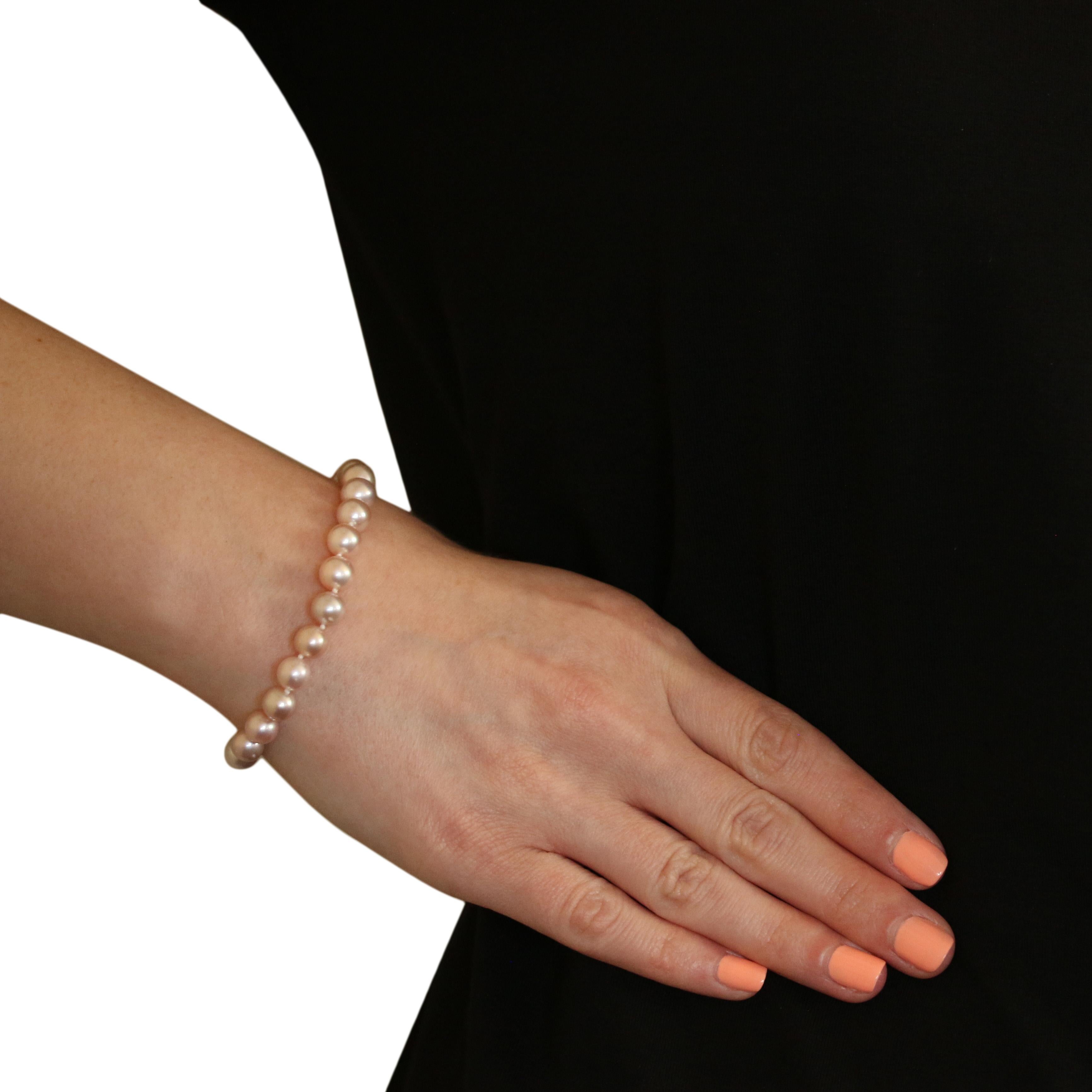 Metal Content: Guaranteed 14k Gold as stamped

Stone Information: 
Cultured Pearls
Diameter Range: 6.9mm - 7.5mm

Bracelet Style: Knotted Strand
Measurements: length 7