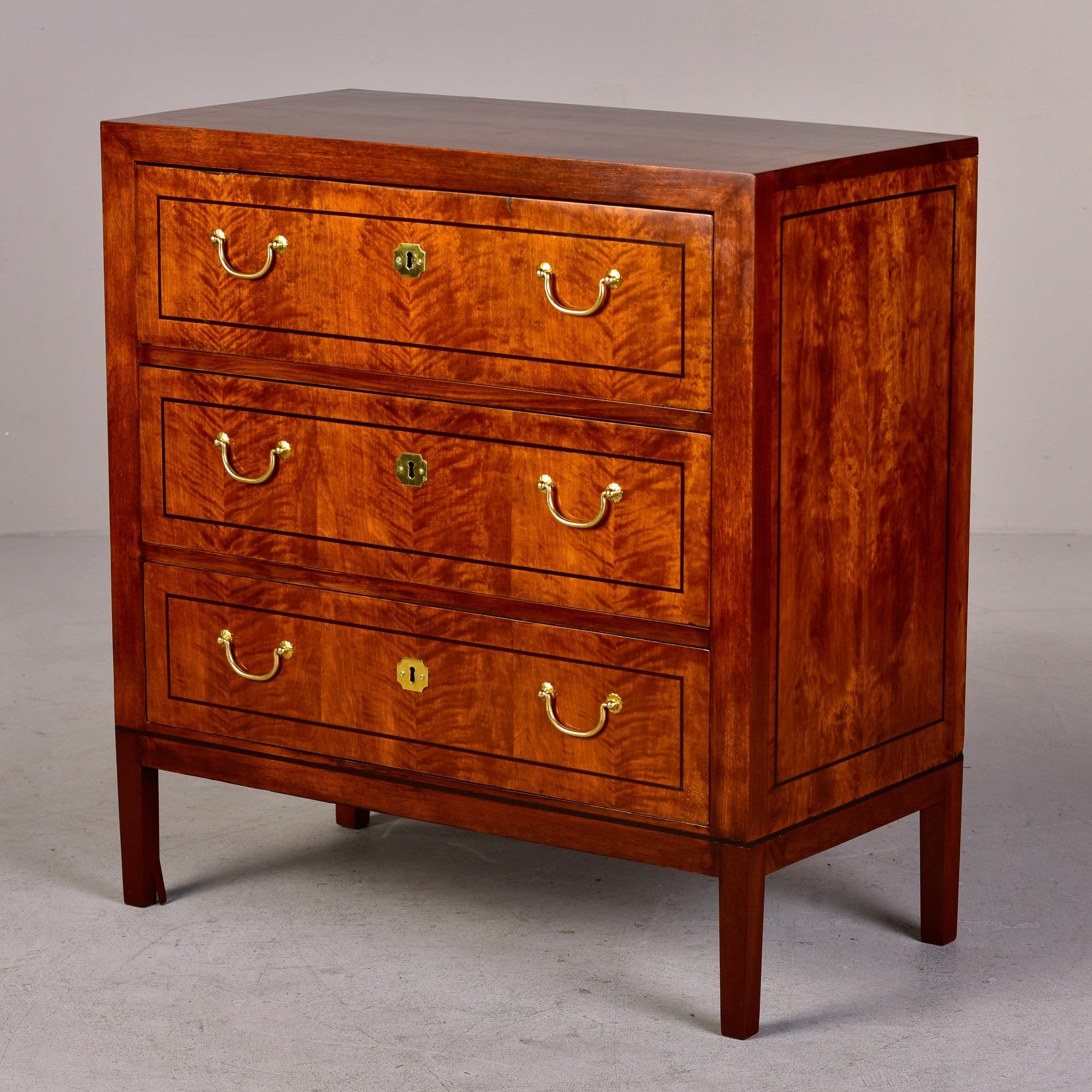 New and custom made for us in England by a family owned and operated cabinet maker. Three drawer chest in birch with classic brass hardware and functional locks. Nicely figured birch is accented with contrasting slender dark inlay border on top,