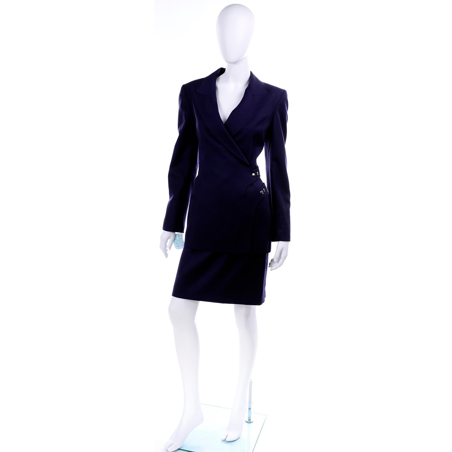 This is a vintage 1990's Claude Montana Paris navy blue wool skirt suit that still has its original tags attached and was never worn! This deadstock outfit includes a slim skirt and a jacket with shoulder pads and front buckles & snaps. The suit