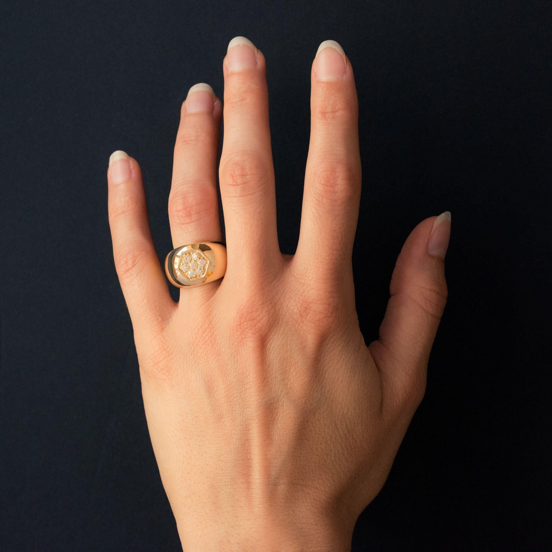 Ring in 18 karat yellow gold.
This large domed band ring is set with a hexagonal shaped design featuring 7 claw set brilliant- cut diamonds. 
Total diamond weight: about 0.30 carat.
Height: 1.14 cm, ring width in base: 2.15 mm.
Total weight: