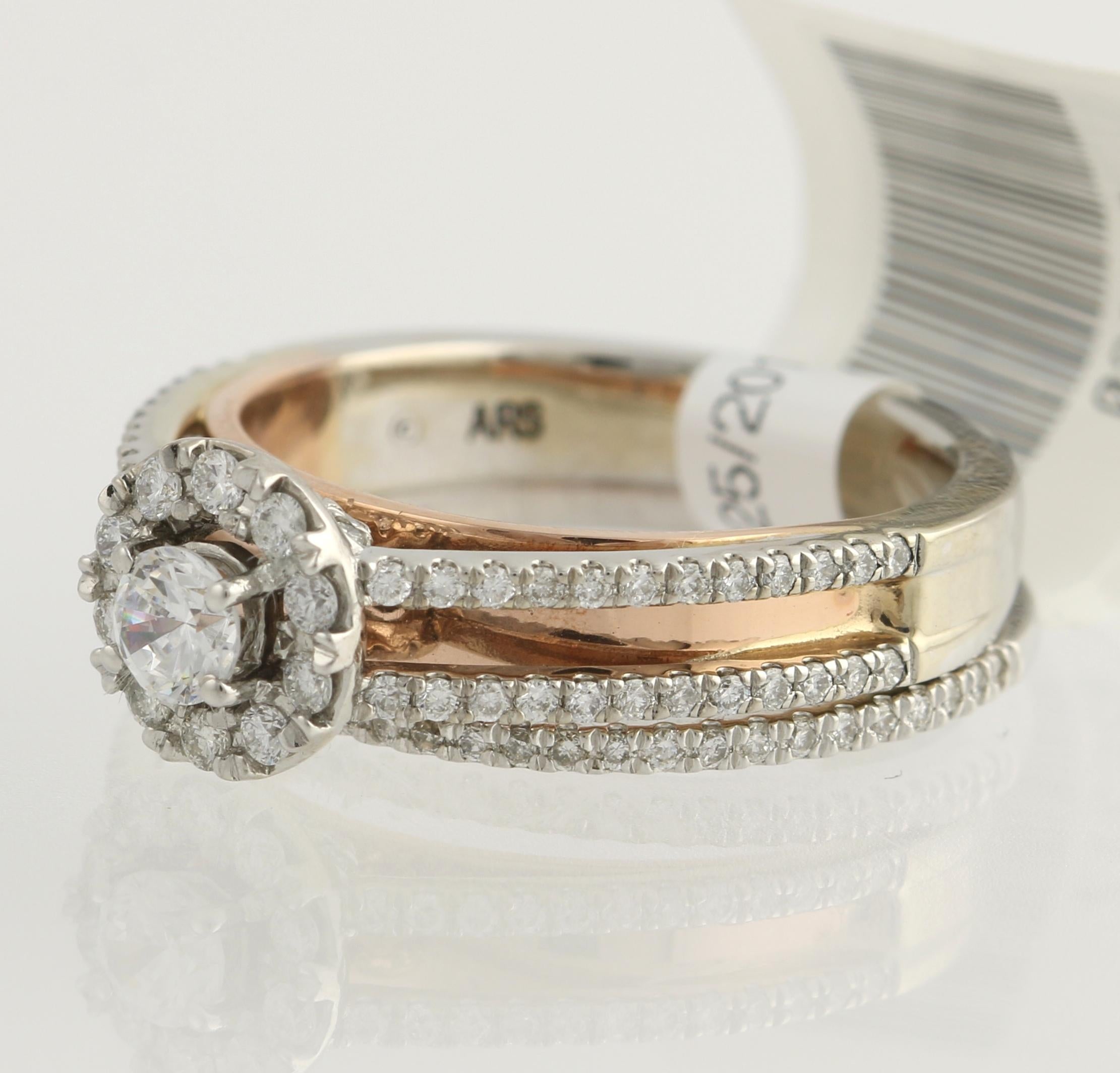 Propose in style with this gorgeous wedding set! Comprised of an engagement ring and matching wedding band, this NEW set is fashioned in popular 14k white gold and includes a bridge band of 14k rose gold. The engagement ring showcases a round cut