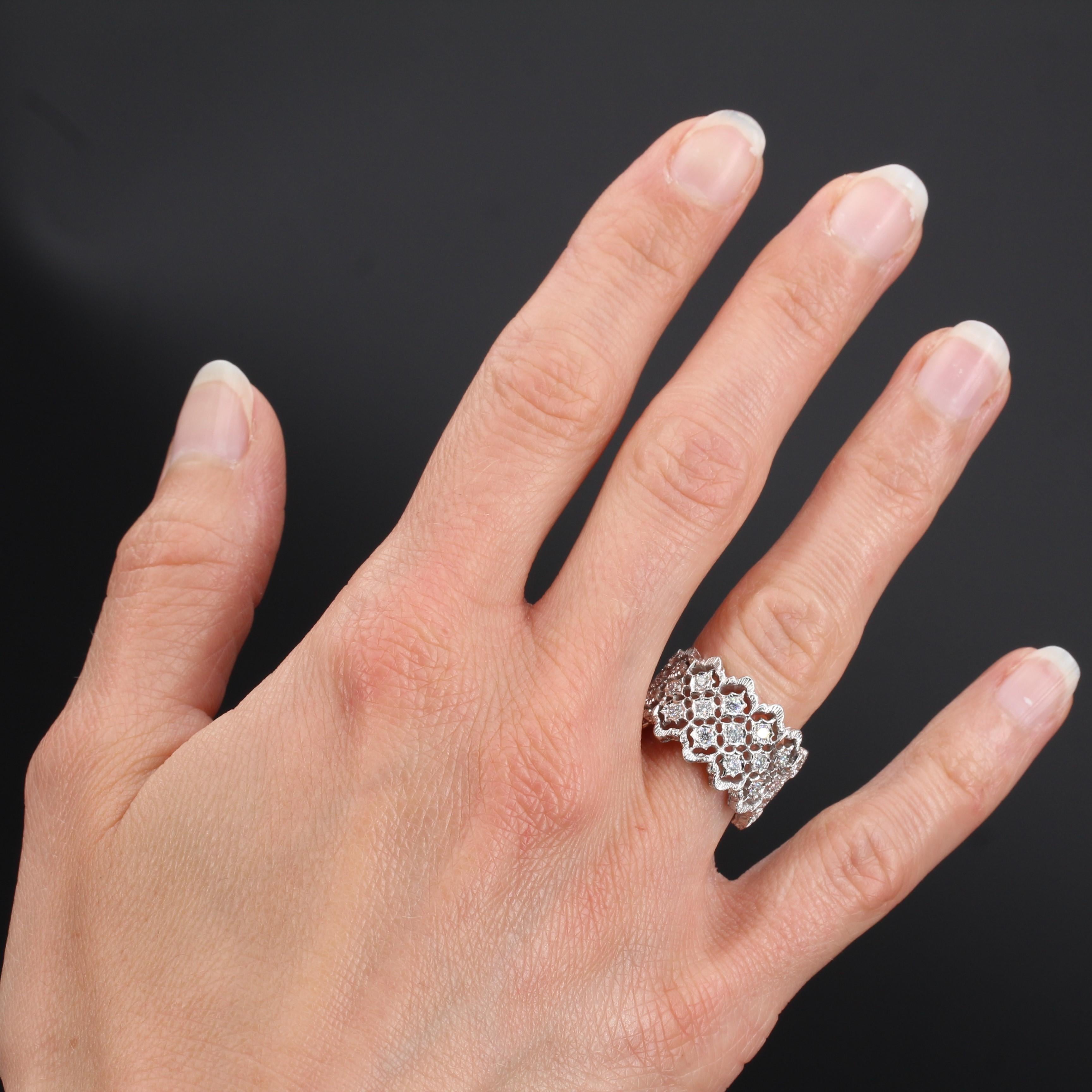 Ring in 18 karat white gold. 
This wide diamond ring features white gold filigree set with 13 small brilliant- cut diamonds edged with gold filigree. 
Total diamond weight: about 0.34 carat.
Width: 1.3 cm
Total weight: about 7.4 g.
US Size : 6,5 .