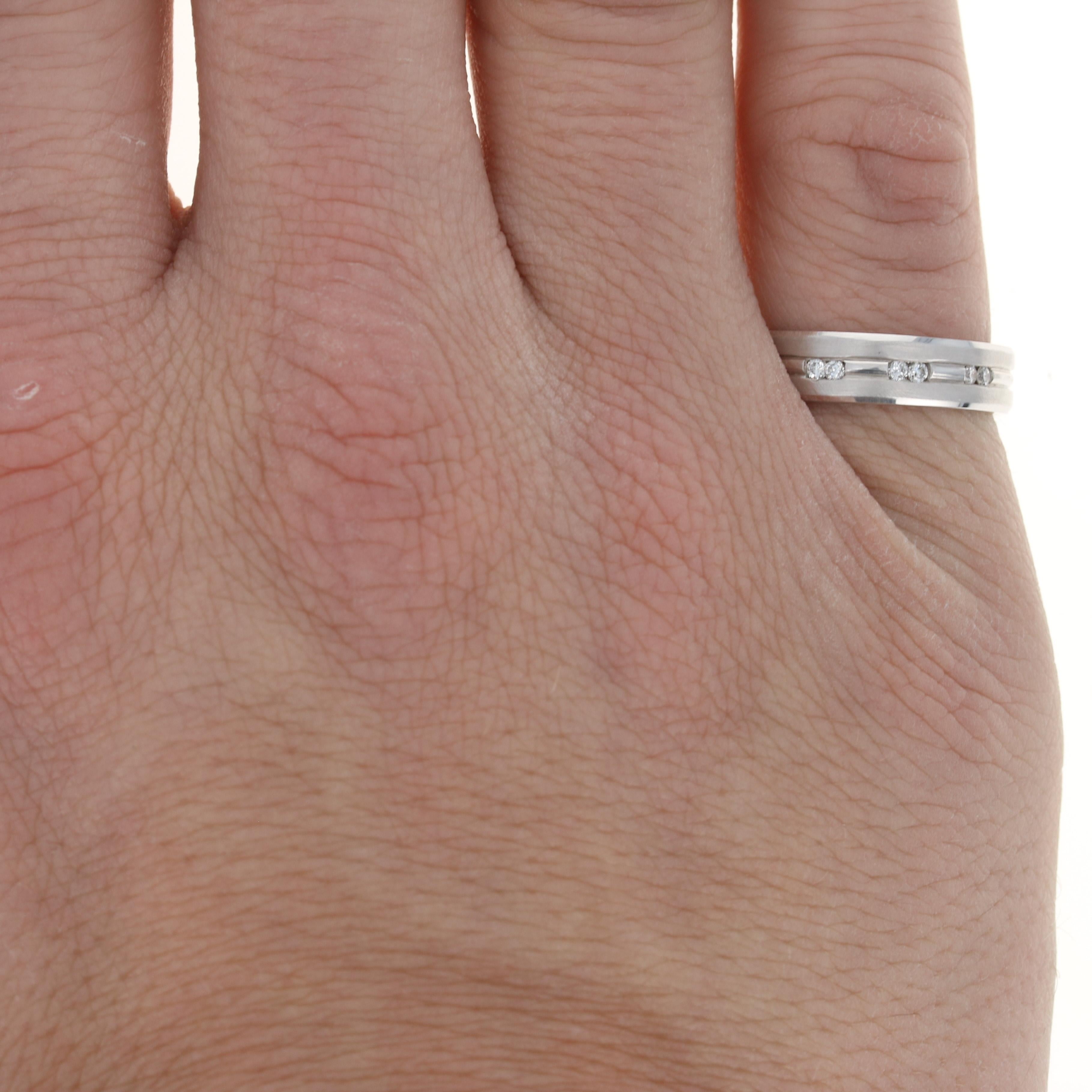 Keep the magic alive when you pledge your love with this fine wedding band! Crafted in 14k white gold, this NEW piece features a comfort-fit band and brushed exterior adorned with six natural diamonds. The round cut diamonds are inset in the center
