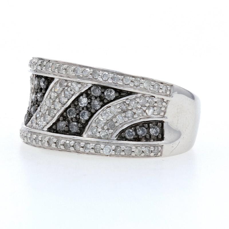 Add some sparkle to any of your jewel-toned ensembles with this chic ring! Fashioned in sterling silver, this NEW piece features a wave-inspired mosaic adorned with natural diamonds. Black embossing behind some of the diamonds creates an