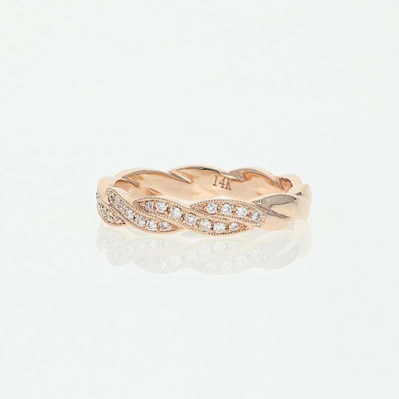 Absolutely stunning, this NEW band will be a wonderful choice to celebrate your marriage! Crafted in glowing 14k rose gold, this ring showcases a meaningful woven design adorned with shimmering natural diamonds outlined by milgrain accents.   

This