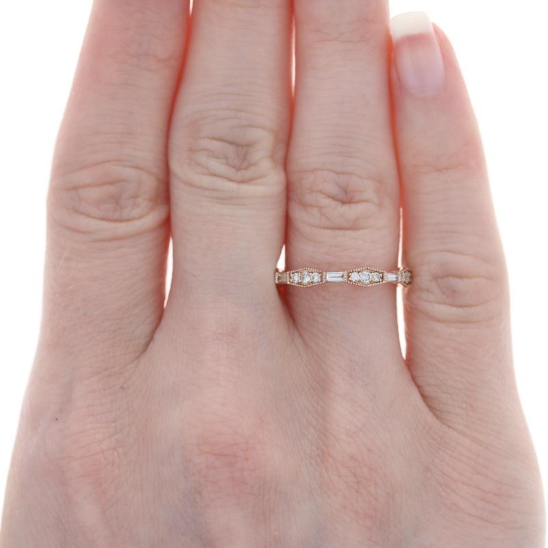 Celebrate and symbolize your marriage with this sparkling NEW band! Crafted in 14k rose gold, this heirloom-quality ring showcases a geometric design set with baguette cut and round brilliant cut natural diamonds highlighted by sweet milgrain