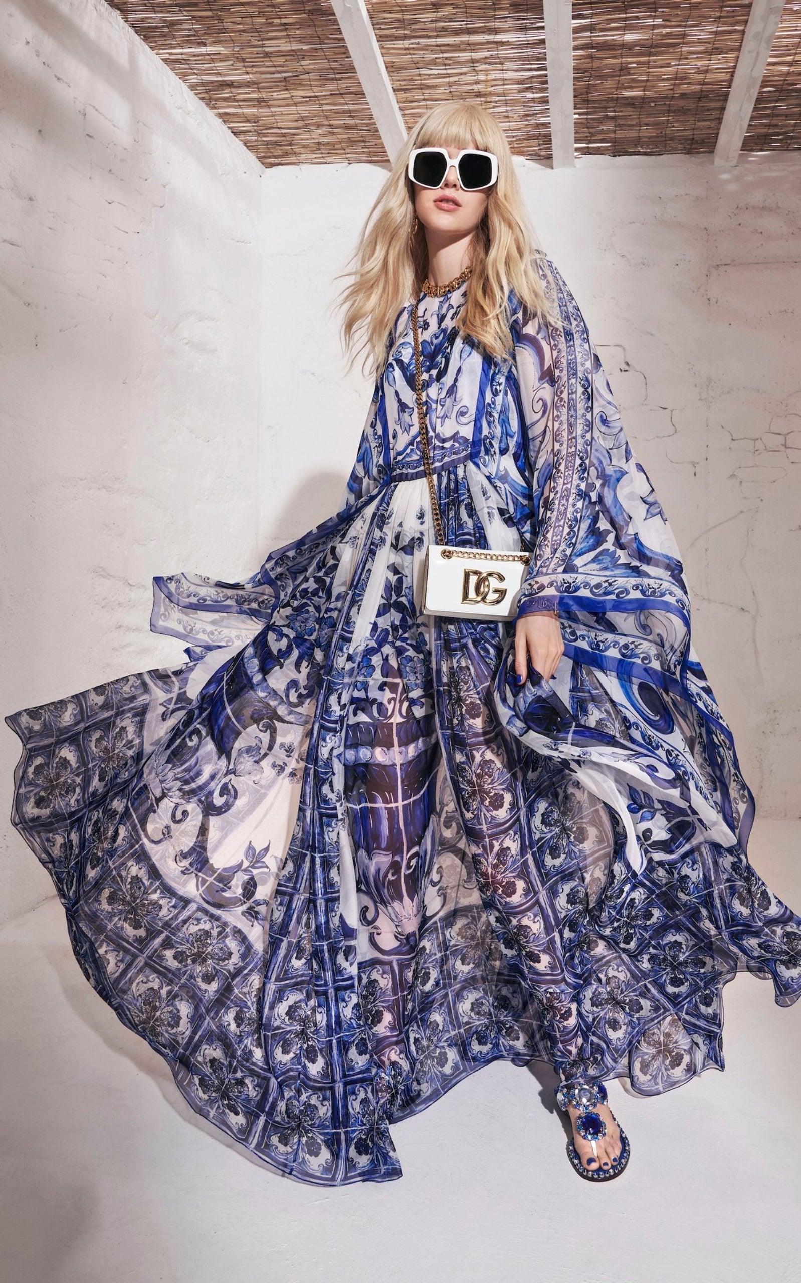 In its Blu Mediterraneo line, Dolce & Gabbana wants to emphasize the concept of beauty, lightness and femininity with the warm harmony of blue and white. 
Crafted of silk chiffon, the kimono-sleeve maxi dress is defined by large painterly prints and