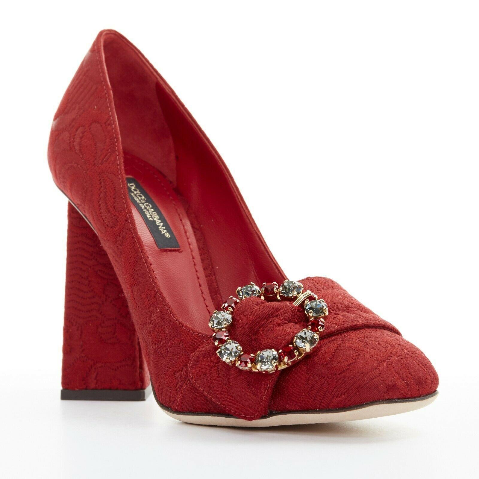 new DOLCE GABBANA red floral jacquard jewel buckle angular block heel EU35
DOLCE &GABBANA
Red floral baroque upper. 
Silver and red jewel circular buckle detail. 
Tonal stitching. 
Square angular high heel. 
Rounded square toe. 
Padded red leather