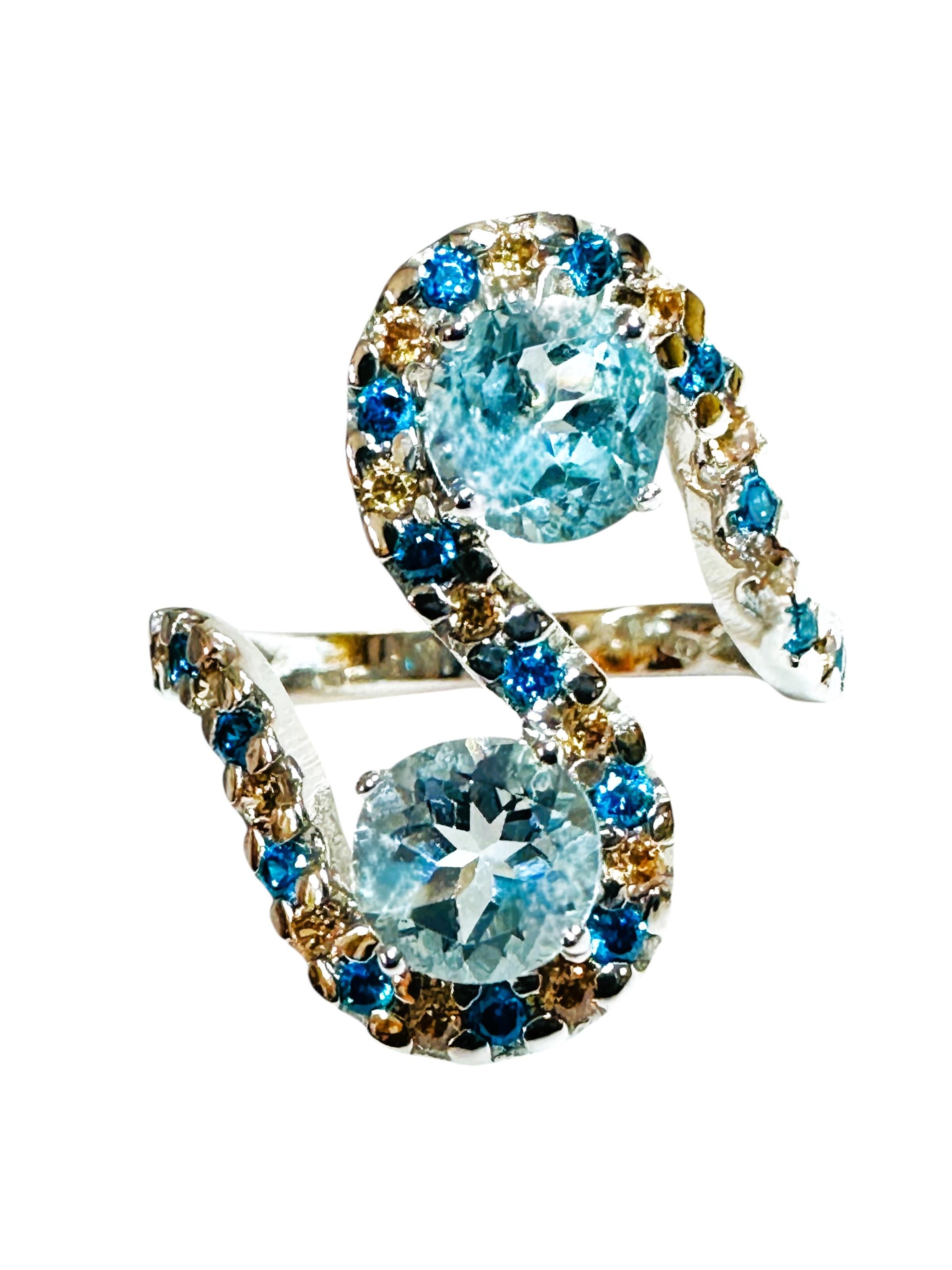 The ring is just stunning!  It is a size 6. The two round stone is from Africa.  They are beautiful fancy cut round stones and each are .80 cts.  They are very high quality stones. They measures 5.8 mm and they are surrounded by swirls of diamond