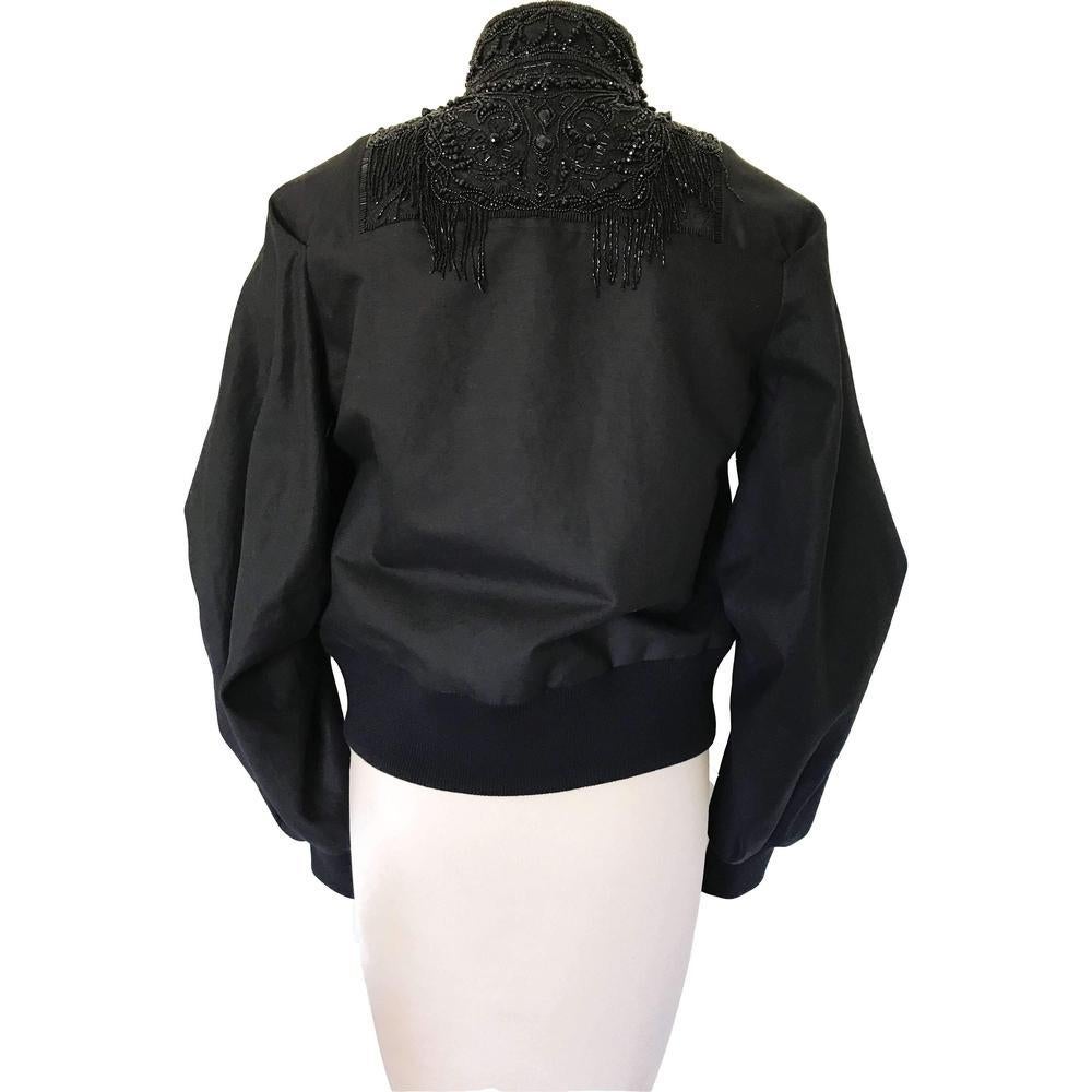 Dries Van Noten’s takes a lavish approach to the classic bomber
jacket, delicately designing this black style with ornate
bead embellishments on the front and back.
Brocade yoke and collar with fringed beadwork
High collar
Batwing