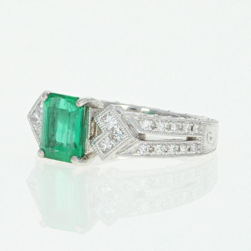 Resplendent beauty and exceptional quality unite to create this captivating piece! Composed of 900 platinum, this luxurious NEW ring features a vivacious emerald solitaire accompanied by sparkling white diamonds which are highlighted by the mount’s