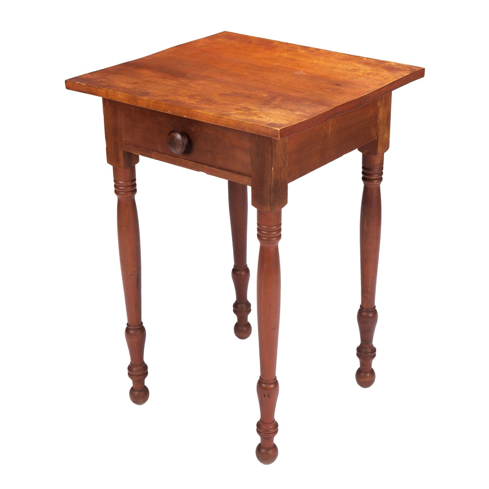 American country Sheraton one drawer stand. The square single board top is fitted to a conforming apron housing a single drawer with original mushroom knob. The square corner dies continue into stout simple turned legs terminating in ring and button