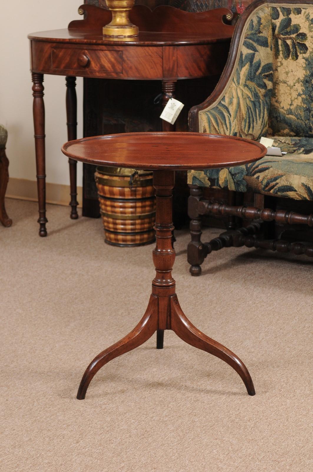 New England Federal candle stand table in walnut with circular, tilting mechanism, tripod base with tapered curved legs.