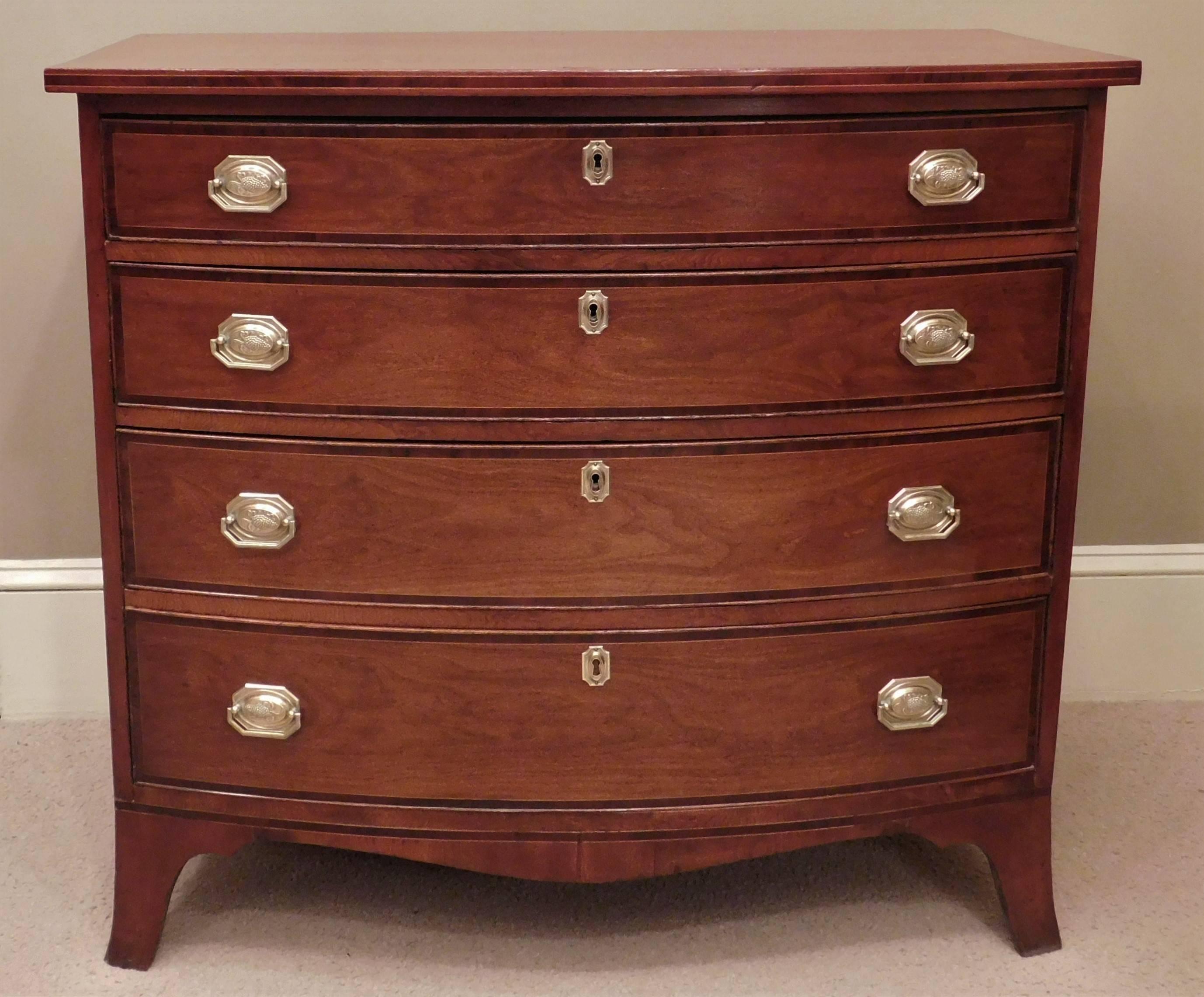 This federal chest is French polished cherry with mahogany and boxwood banding and pine secondary. It has four graduated drawers French bracket feet shaped skirt and old replaced handmade brass pulls. It has a rich glow and excellent patina.