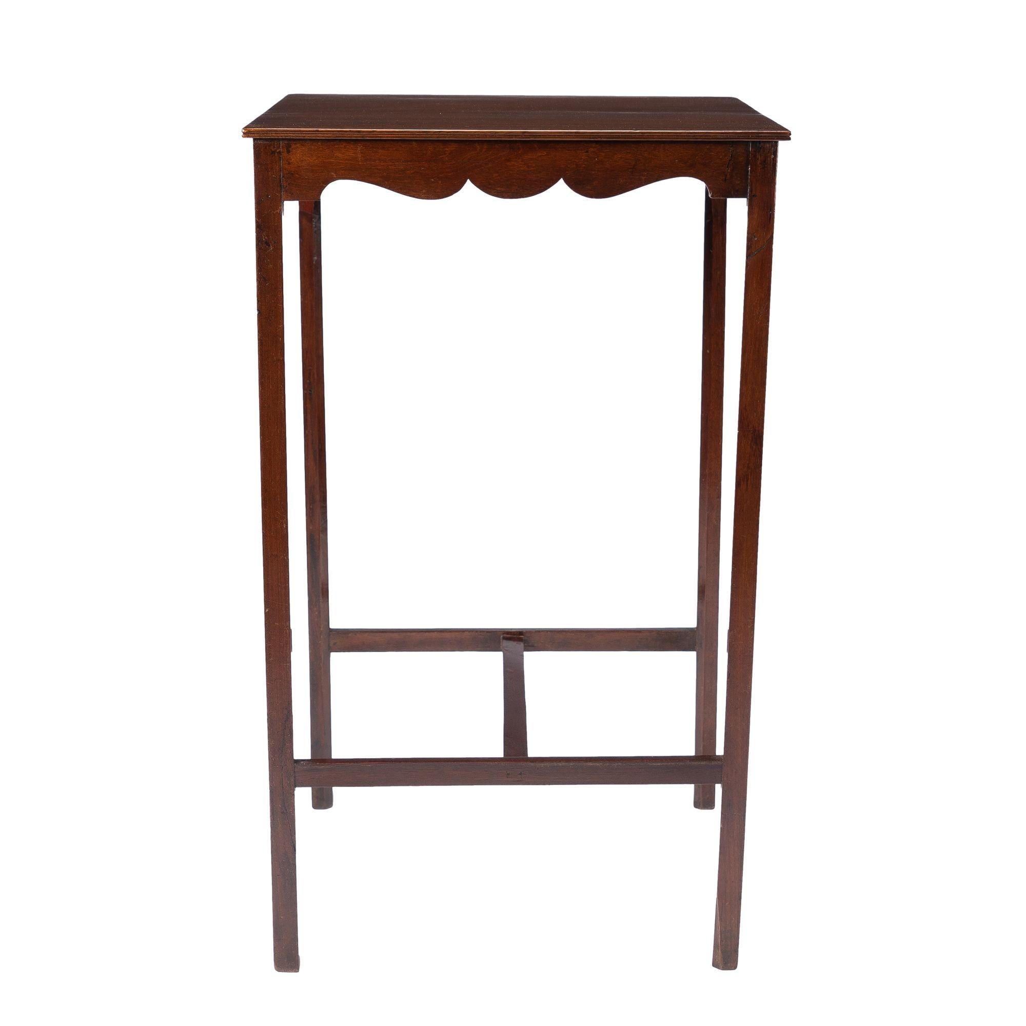 American Hepplewhite mahogany dressing stand. The stand is fitted with a square beaded edge single board top on a conforming scollop cut apron on fine square legs joined by an 