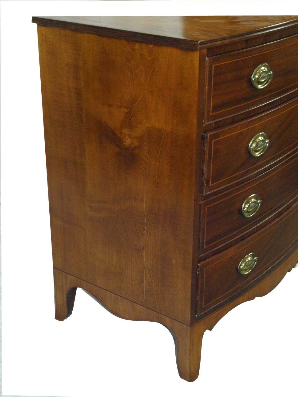 New England Hepplewhite inlaid mahogany and maple bow front chest, the top, sides and feet are maple and the drawers are mahogany; the top inlaid with a band of boxwood and mahogany; drawers retaining their original brass oval pulls are inlaid with