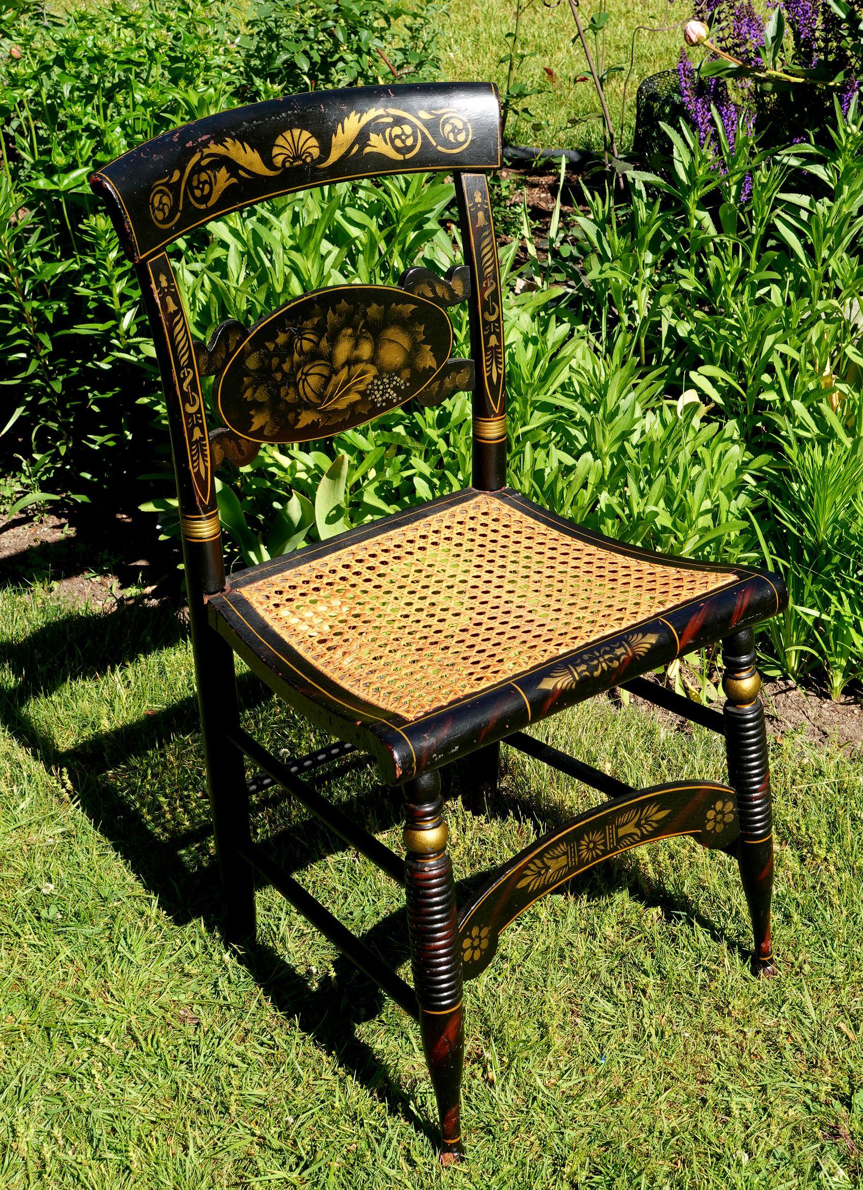 A New England Hitchcock Style/Fancy chair. Hand painted/stenciled with a deep and rich patination from years of good wear. The seat is woven rush seats and is in very good condition.

Width: 17 in (43.18 cm)
Depth: 15.25 in (38.74 cm)
Height: