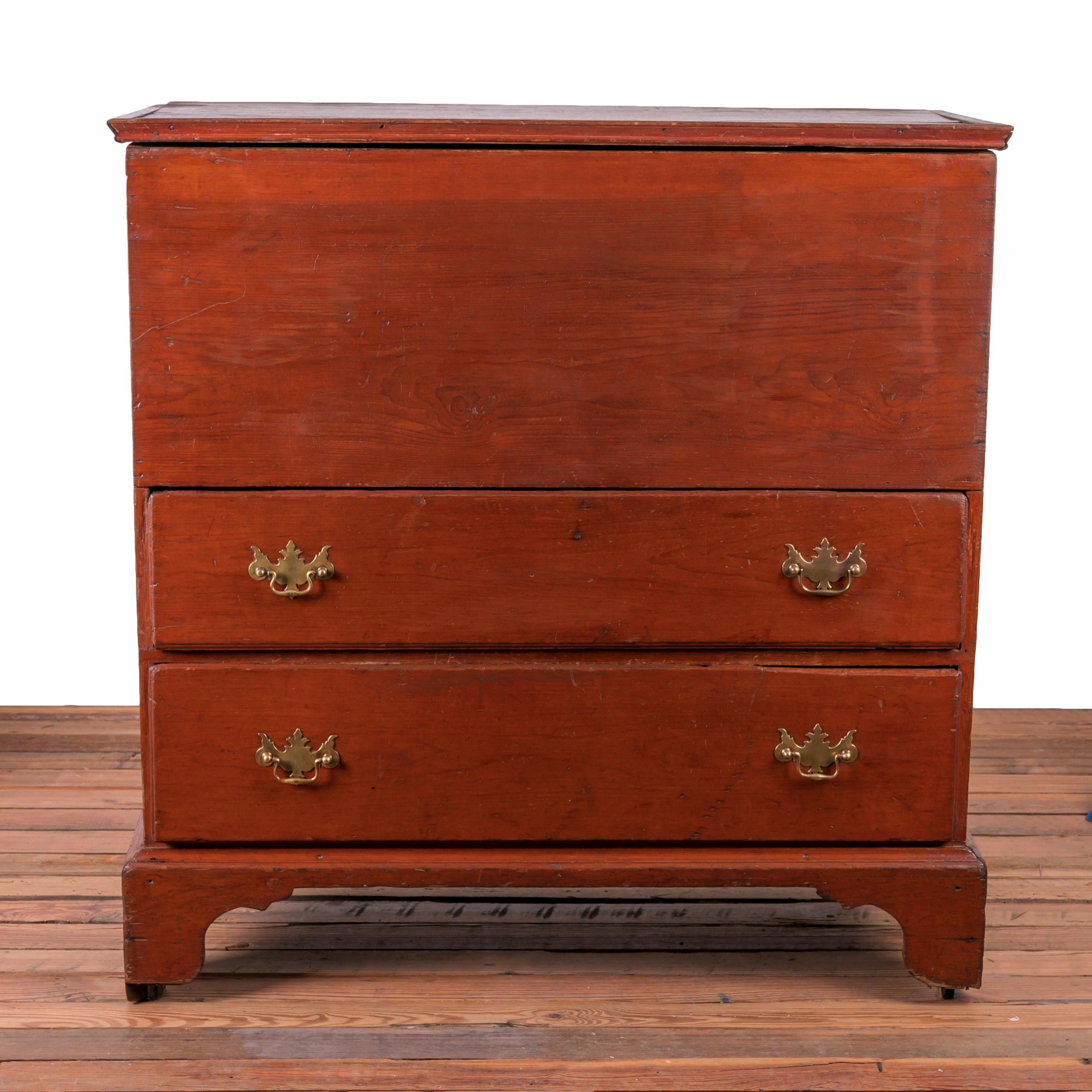 A New England mule chest, 19th century.

Pine with red wash, moulded lid and drawers, solid bootjack ends with attached shaped and moulded apron.

40 ¼ inches wide by 19 ¼ inches deep by 41 inches tall 

