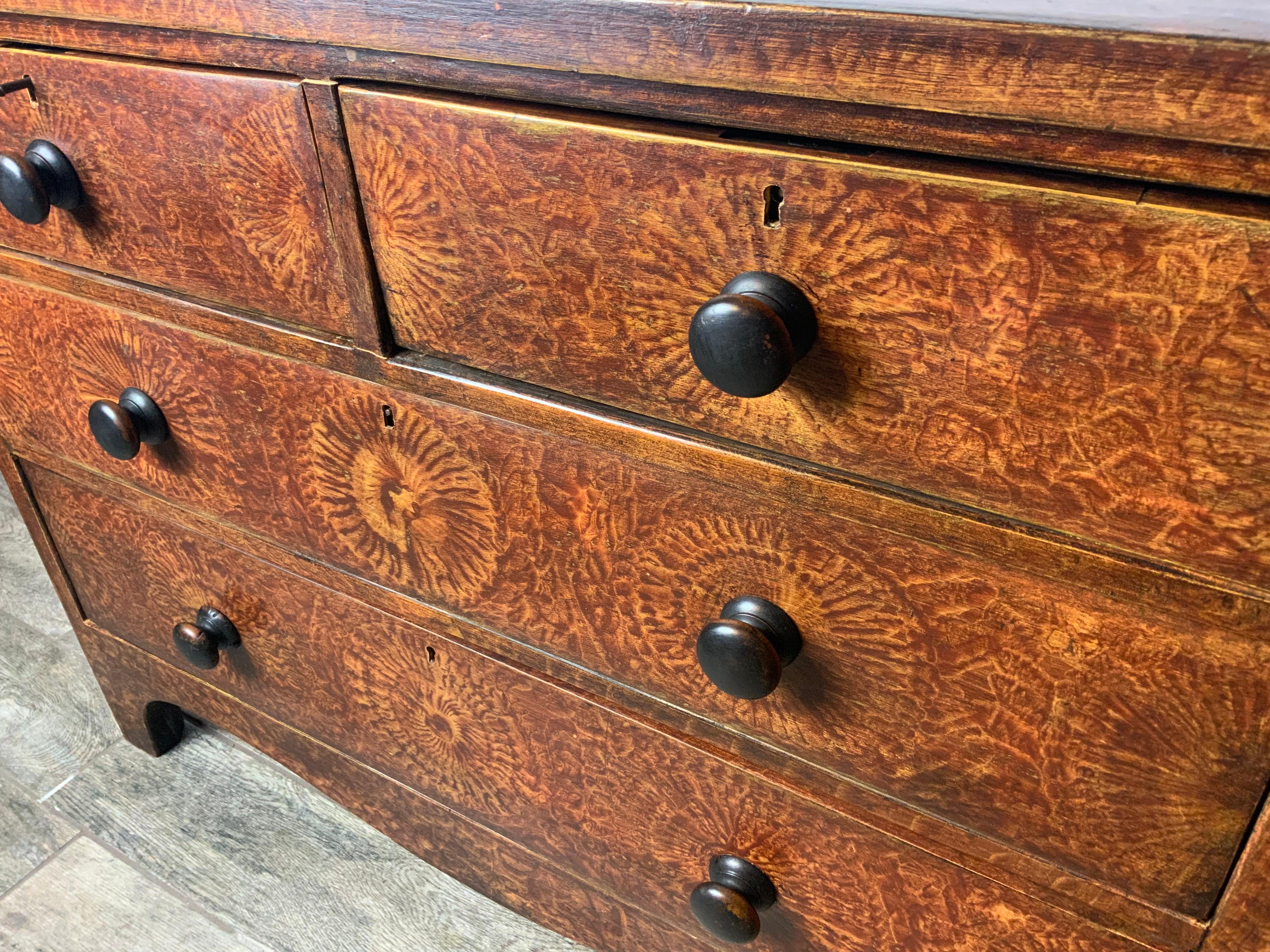Superb example of a Late 19th century primitive paint decorated New England four drawer chest in vinegar sponged paint. The nicely dovetailed drawers are made of Butternut and Cedar and the case is Pine.  The original paint is in very good condition
