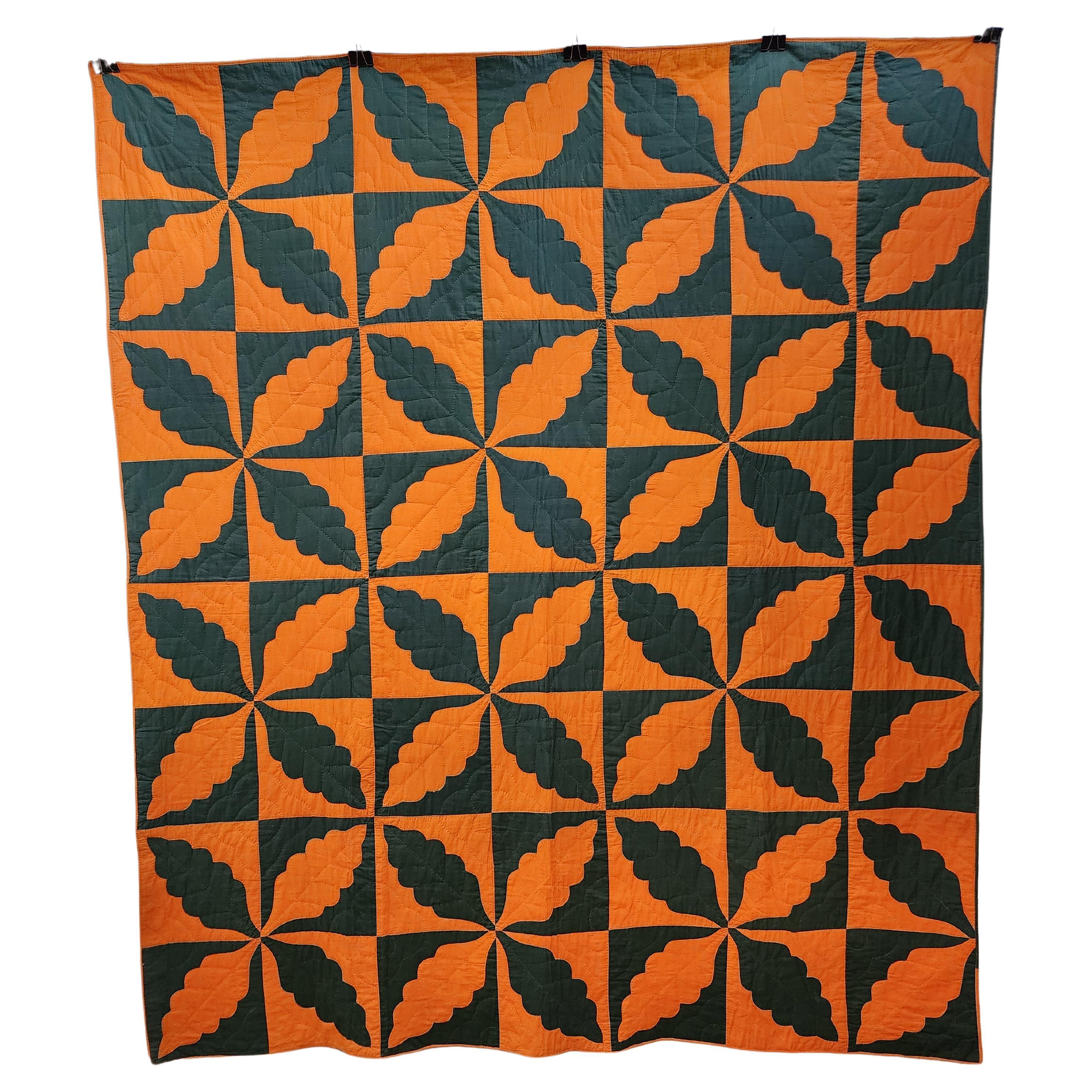 Striking and beautiful New England quilt with oakleaf pattern. Investor investive condition with a highly modernist design pattern. Found in Maine, this quilt made from pumpkin orange and a dark modeled blue green cotton and is in excellent