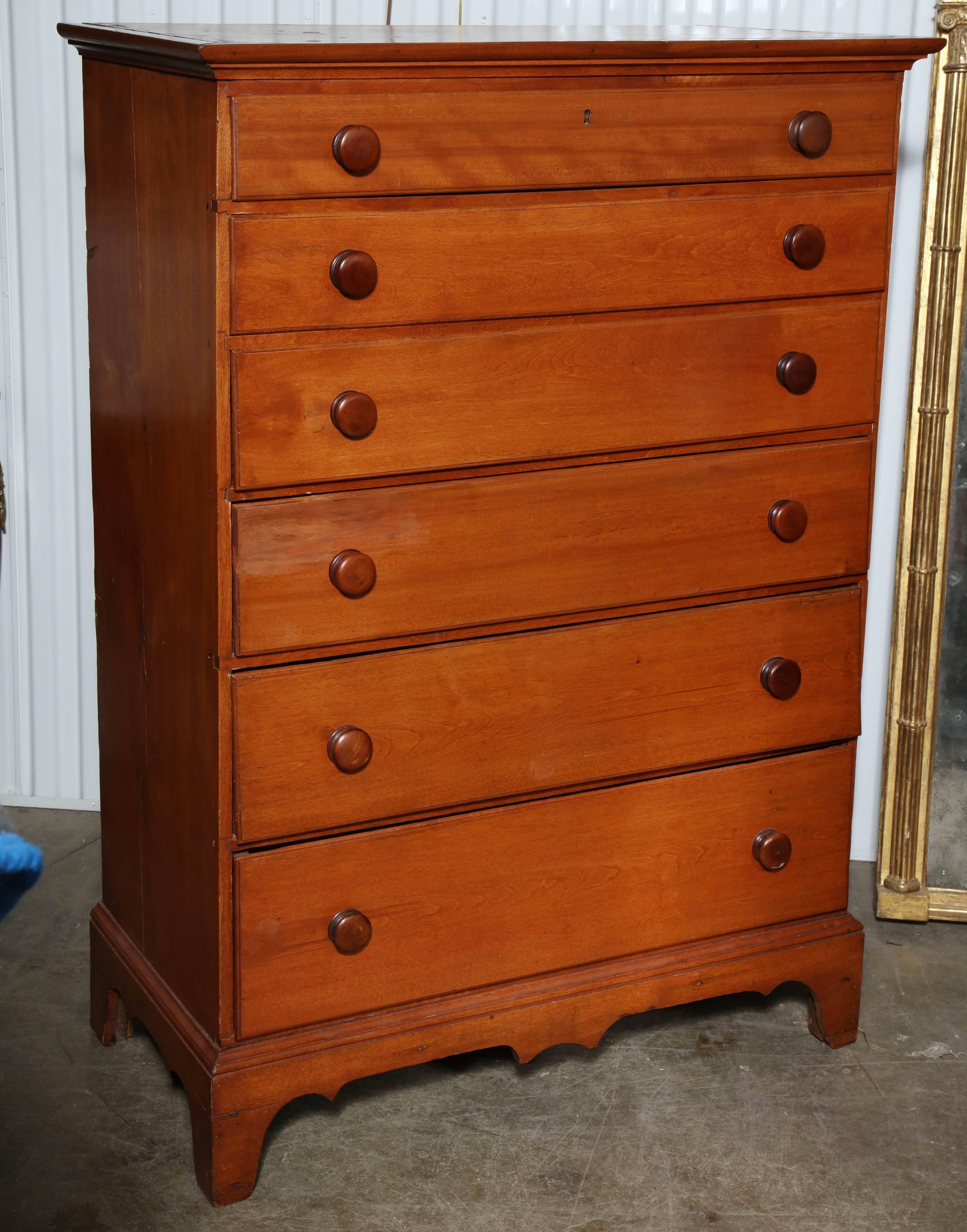 American New England six-drawer birch wood High Daddy tall chest of drawers with graduated drawers on a bracket feet with a pendant apron.