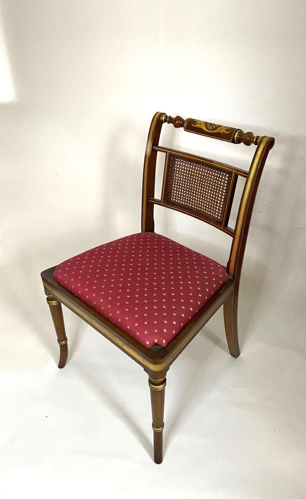 This NEW  Wood & Hogan English-Made Regency Style Faux Rosewood Side Chair is an exquisite piece of furniture that embodies the elegance and craftsmanship of the Regency era. Crafted with meticulous attention to detail, this chair boasts a faux