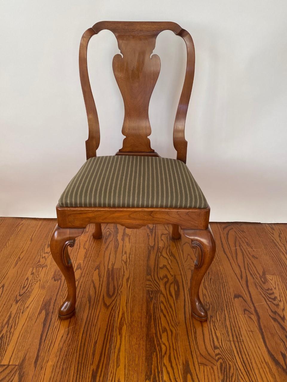 New graceful English-made Wood & Hogan Queen Anne style Walnut side chair featuring a figured wonderfully vase shaped back splat and hand-carved solid Walnut cabriole legs which terminate with a pad foot.  Upholstered slip seat.

Matching armchair