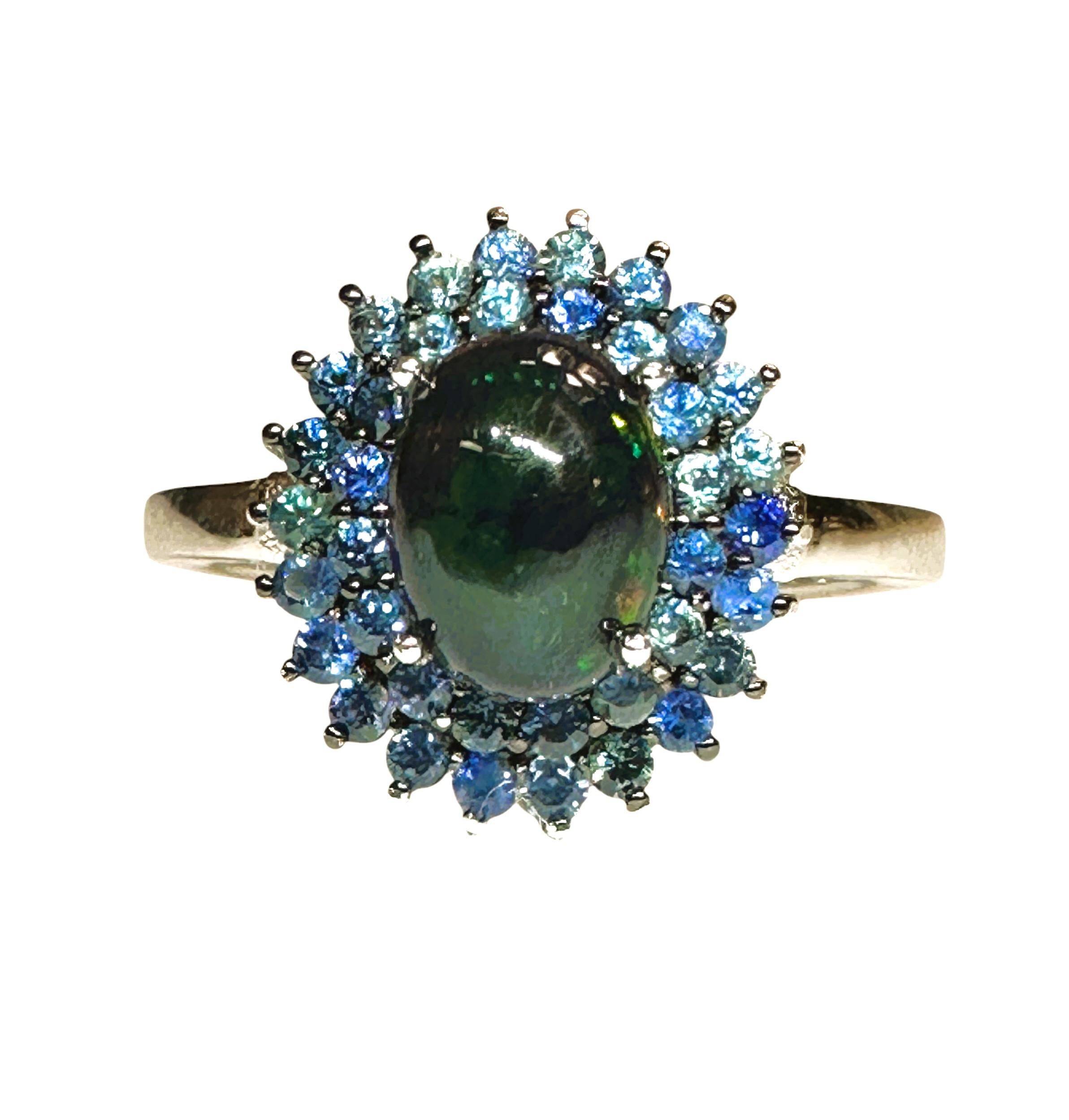 This ring is so gorgeous!  The opal is so beautiful.  It changes color in different lighting.  The Opal comes from Ethiopia and they are prong held and surrounded by two circles of diamond cut  Blue Sapphires.  The ring is a size 7.   The ring is