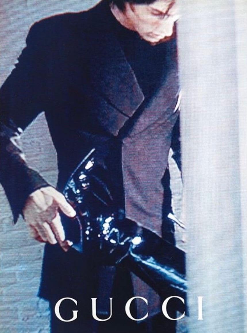 Presenting a pair of iconic black patent leather Gucci heeled boots designed by Tom Ford. From the Fall/Winter 1997 collection, these boots debuted on the season's runway and were also highlighted in the season's ad campaign, captured by Mario