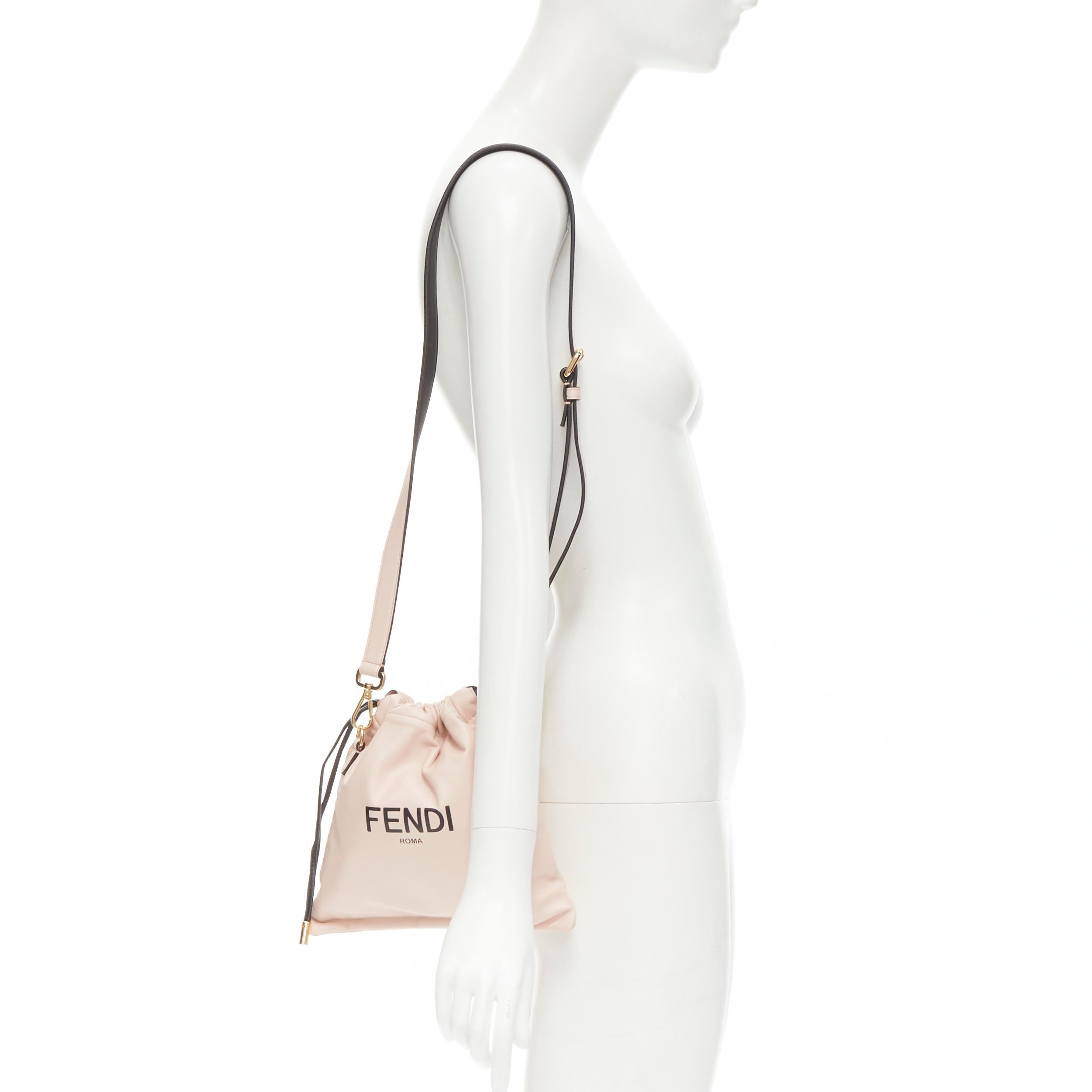 new FENDI beige pink logo print leather drawstring pouch crossbody bag 
Reference: TGAS/C00747 
Brand: Fendi 
Model: 8BT337 ADM9 F1CN7 
Material: Leather 
Color: Beige 
Pattern: Solid 
Closure: Drawstring 
Extra Detail: Packaging pouch inspired