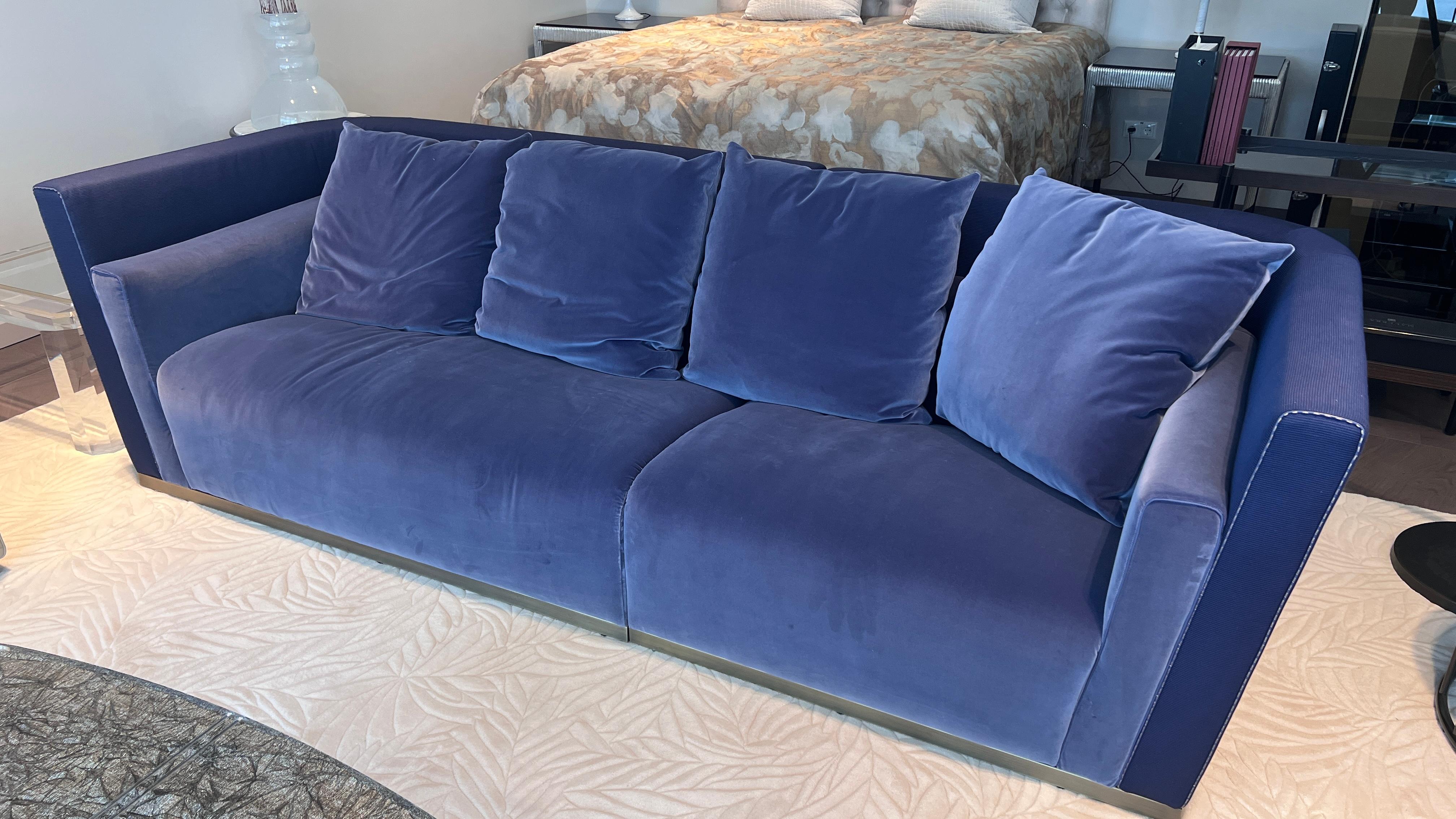 This large Fendi Casa Borromini Sofa is a masterpiece of luxury and craftsmanship. Its elegant frame is upholstered in premium ribbed fabric, offering a refined and textured appearance, the armrest is at a lower height then the frame which is a