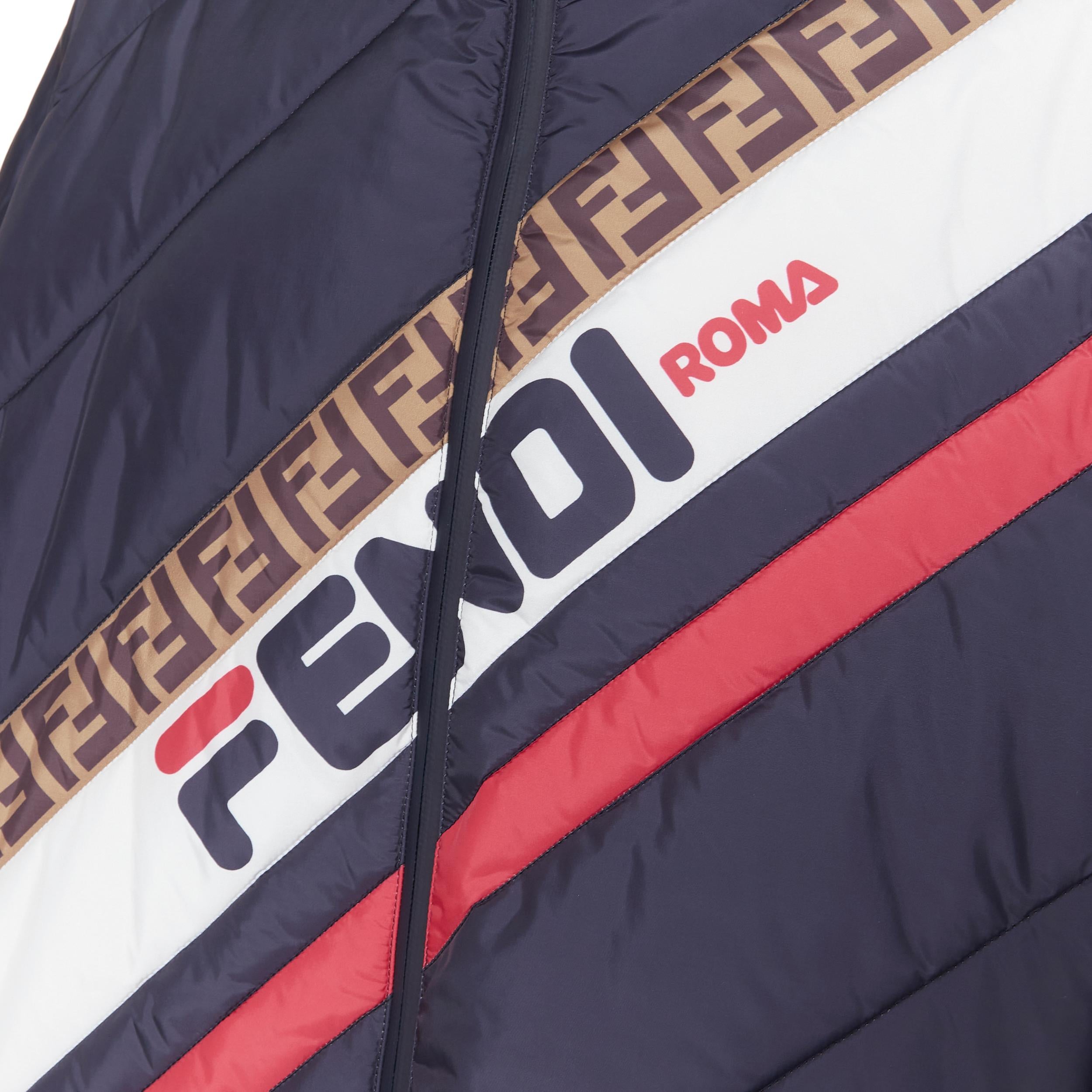 new FENDI FILA Mania blue logo print down padded oversized puffer jacket IT50 L 
Reference: TGAS/B00355 
Brand: Fendi 
Material: Nylon 
Color: Navy 
Pattern: Other 
Closure: Zip 
Extra Detail: Navy blue. Fendi Fila Fendi Mania logo print band across