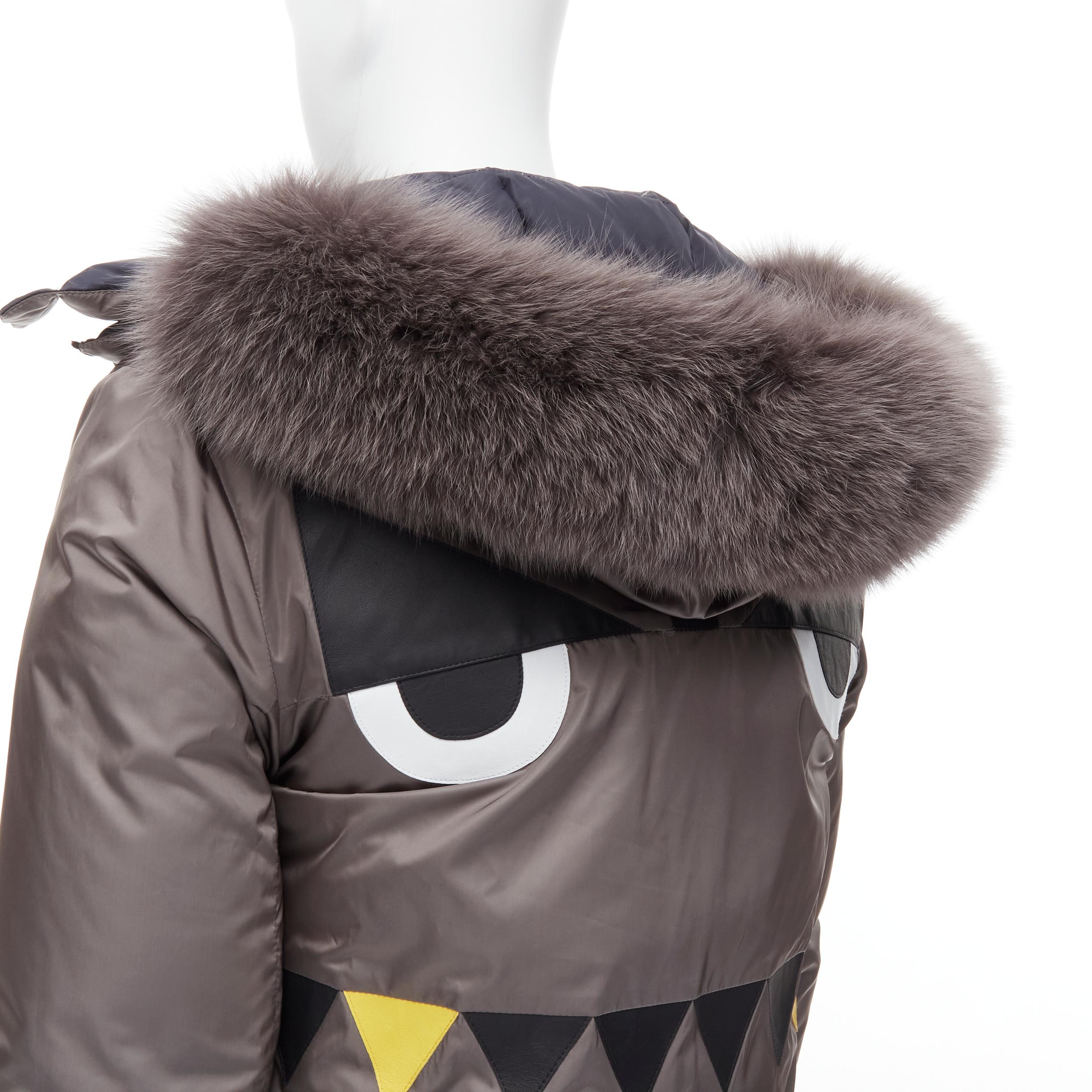 new FENDI Monster Bug grey black reversible fox fur hood down puffer XL EU52
Reference: TGAS/B01594 
Brand: Fendi 
Material: Nylon 
Color: Grey 
Pattern: Solid 
Closure: Zip 
Extra Detail: Fendi Monster Bug face patchwork at back. Reversible from