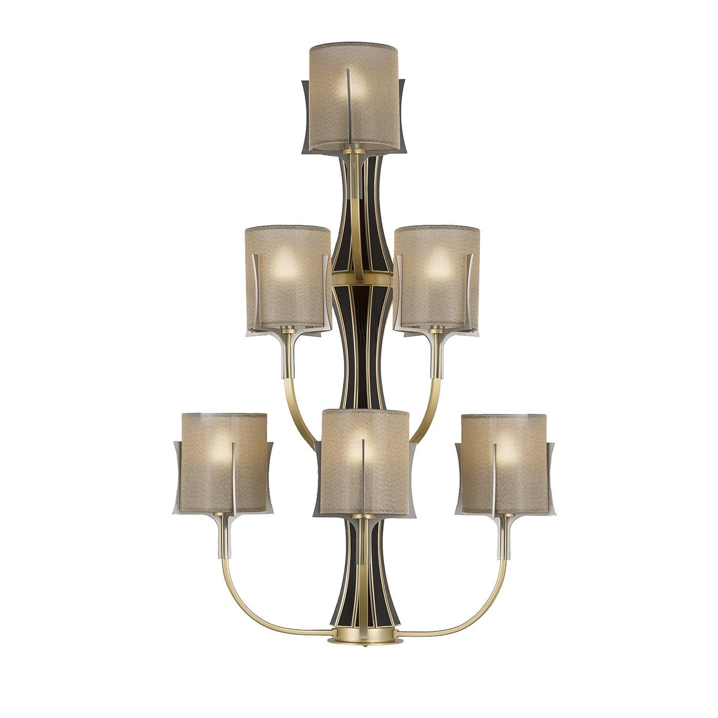 This elegant sconce will be a magnificent addition to an entryway, a hallway, or even a bathroom. Its vertical brass structure is adorned with inserts in black leather, whose color contrasts with the warm glow of the metal. The six lights are