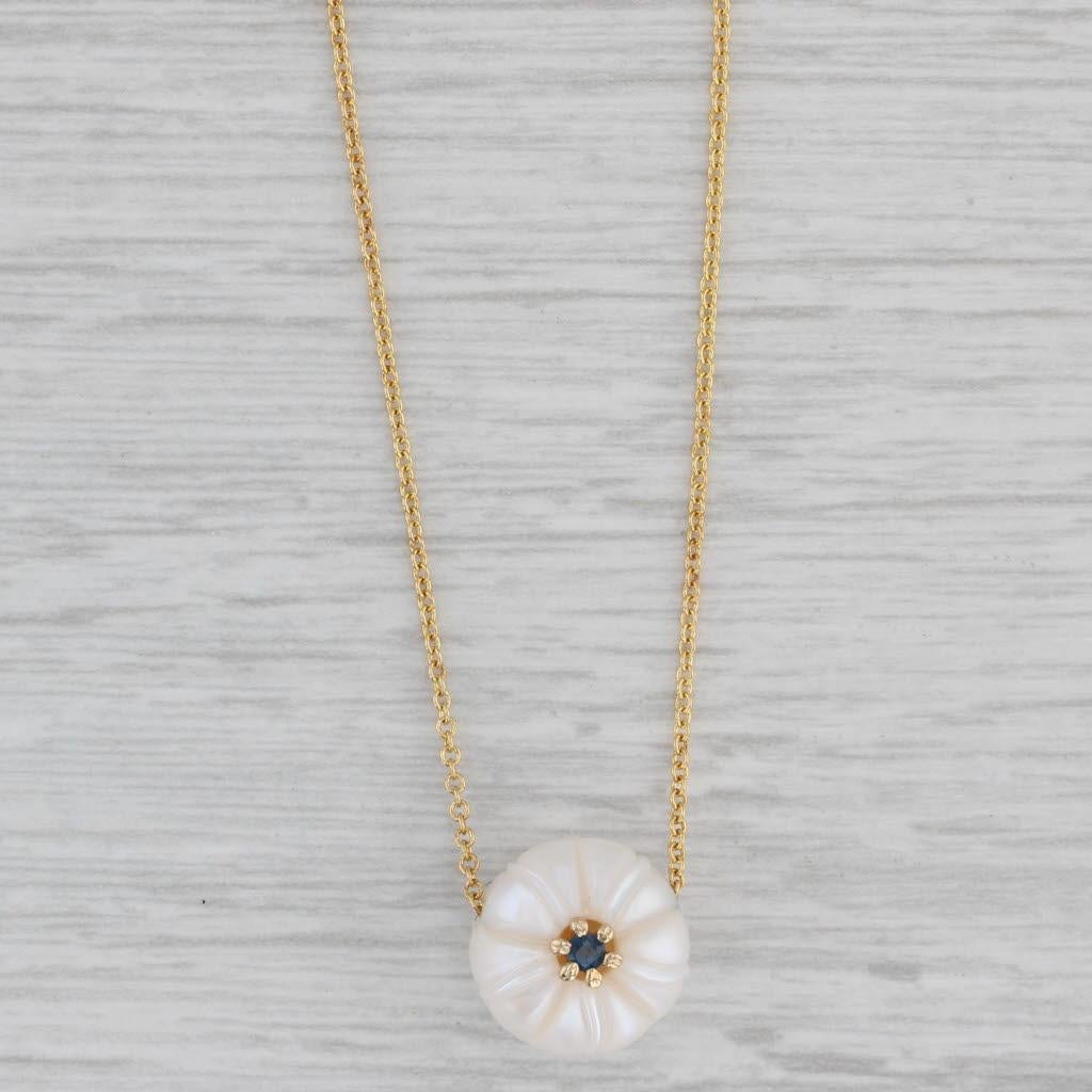 This beautiful set has a pearl pendant displayed on a yellow gold cable chain. One side of the pearl is carved with a morning glory flower design accented by a sapphire centerpiece. This lovely piece has a retail value of $500 so don't pass up this
