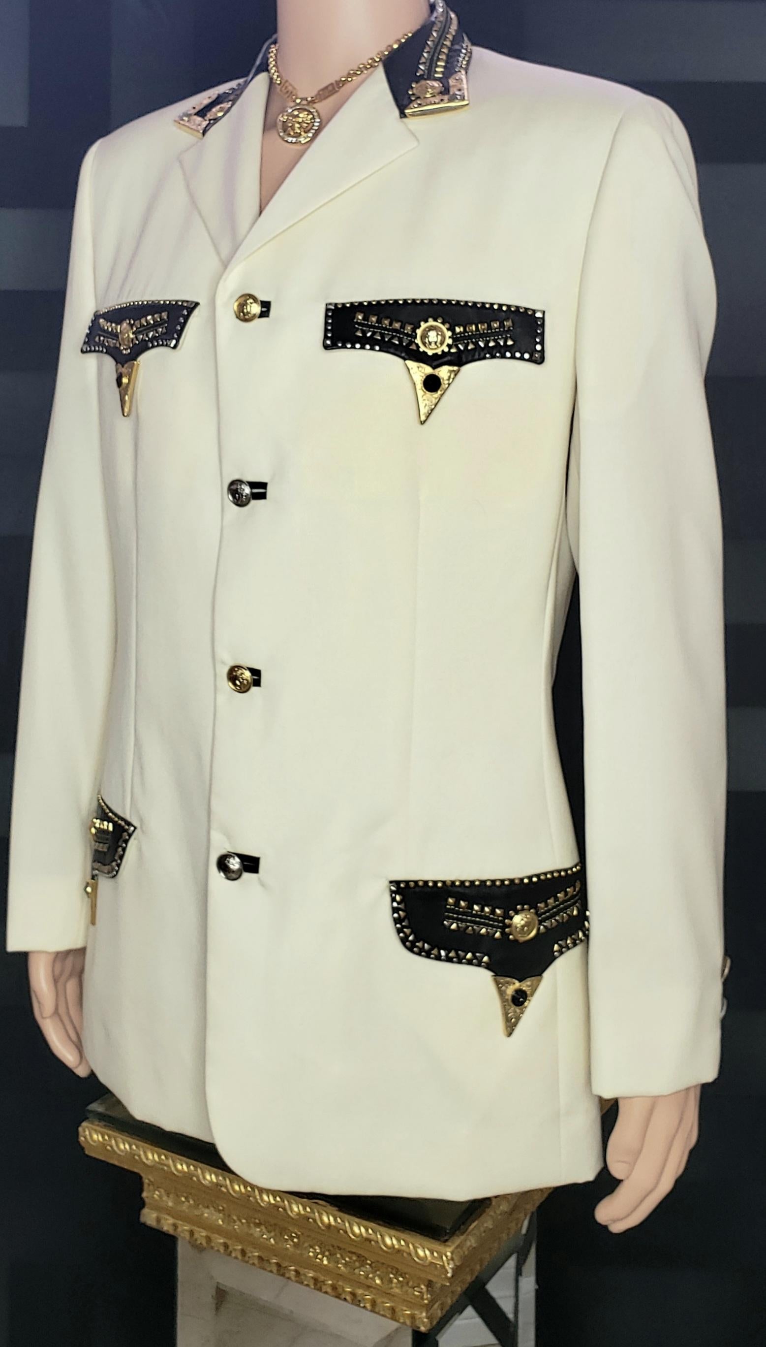 GIANNI VERSACE 

Beige Embellished Blazer Jacket
Leather and Gold-tone Metal trim
Front Gold-tone and Silver-tone button closure
Two buttons on the sleeves

Content: 100% Lana wool

Size IT 48 - US 38 (M)

Shoulder to shoulder 19