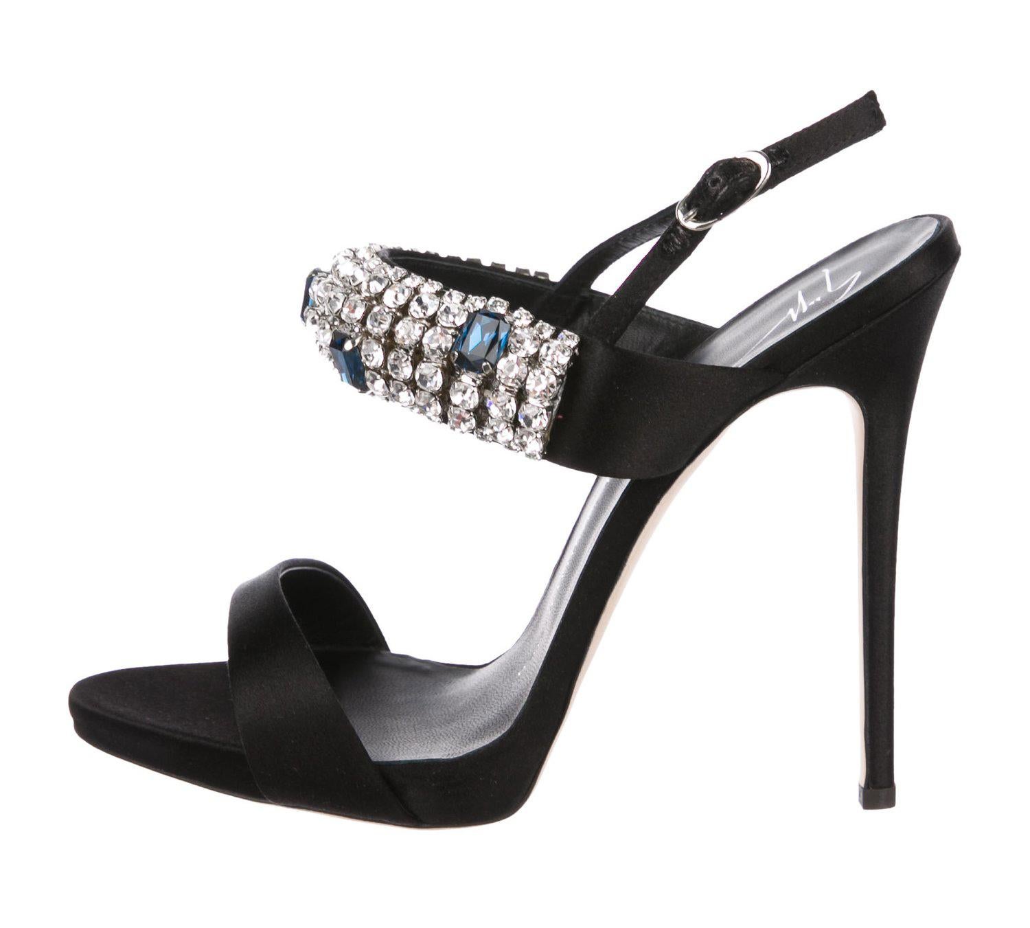 New Giuseppe Zanotti *Carine* Black Crystal Embellished Satin Sandals
Designer size 38 - US 8
Crystal Embellishments at Upper, Covered High Heels, Buckle Closures at Ankle, Leather Sole.
Heel Height - 5 inches.
Made in Italy
New with box.
Retail
