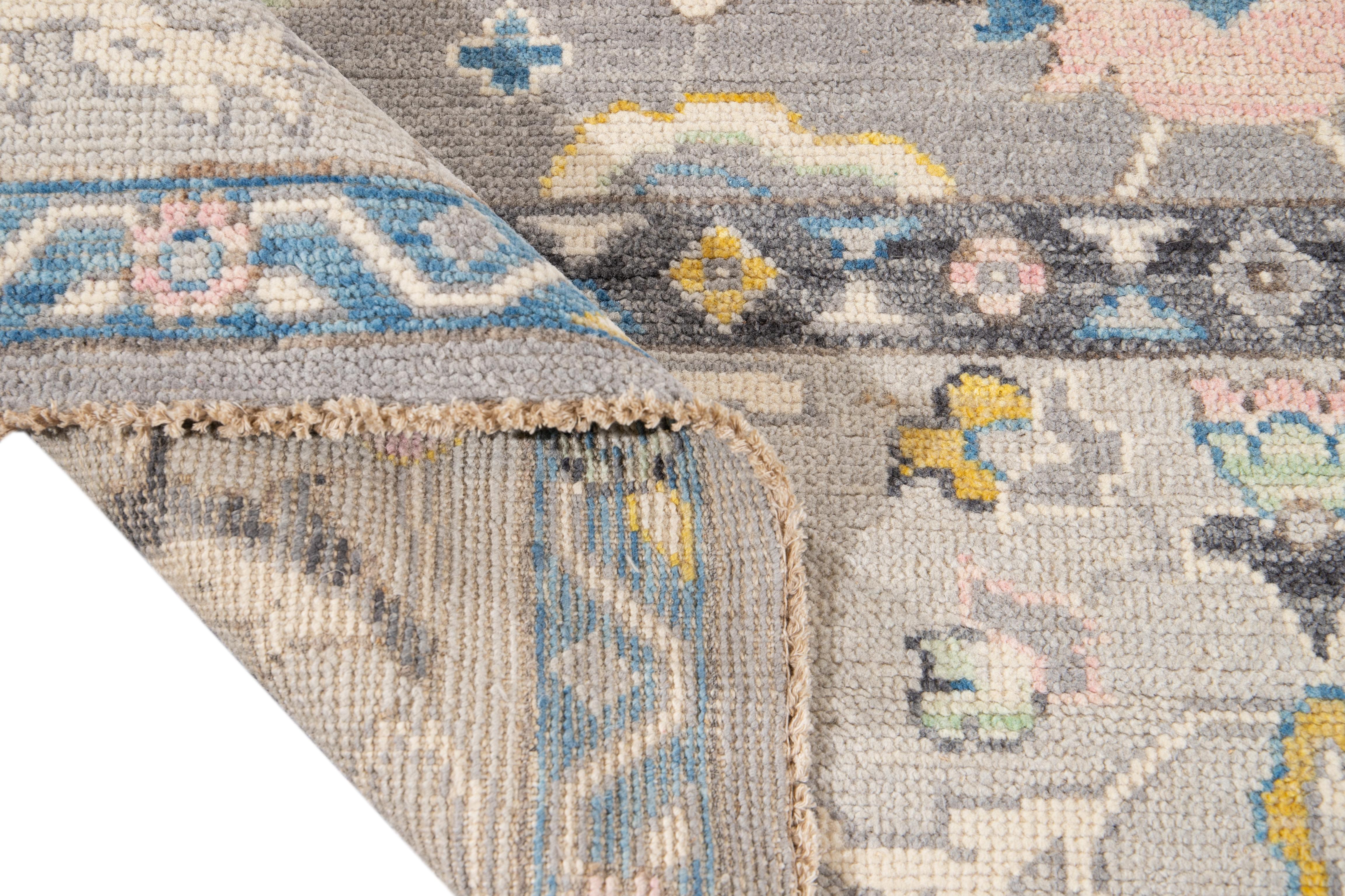 Beautiful contemporary oversize Oushak hand knotted wool rug with a botanical floral design on a gray field and multi-color accents throughout the piece. 

This rug measures: 9' 4