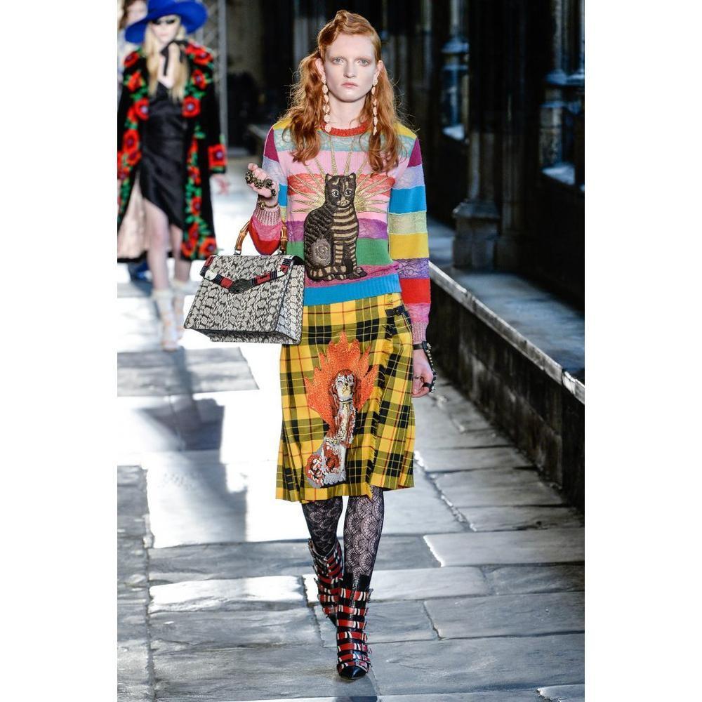For Cruise, Alessandro Michele introduced the embroidered spaniel dog appliqué, found here on the front of this tartan skirt with flame embroideries. 
Yellow and red tartan wool. 
Black leather belt buckle side closure. 
Spaniel dog and flames